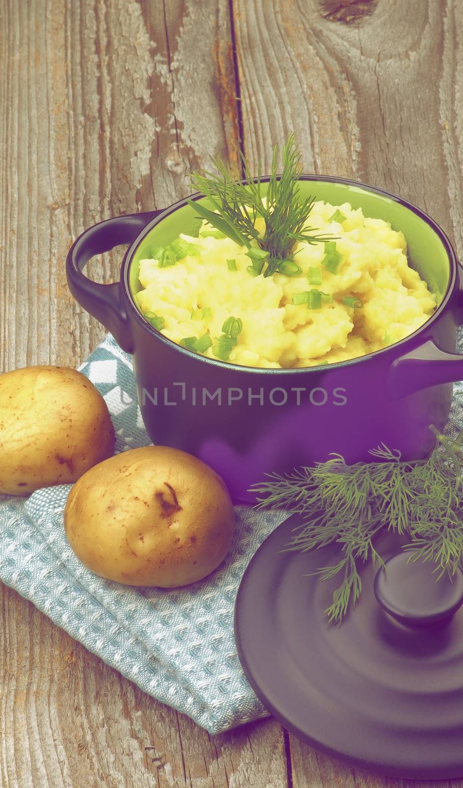 Homemade Mashed Potato with Dill and Spring Onion in Dark Blue Casserole with Lid on Rustic Wooden background. Retro Styled