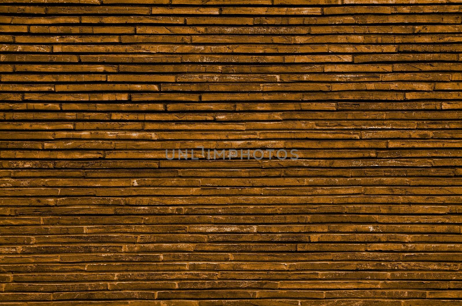 Background of Orange and Sand Colored Plank Stone Exterior Wall closeup