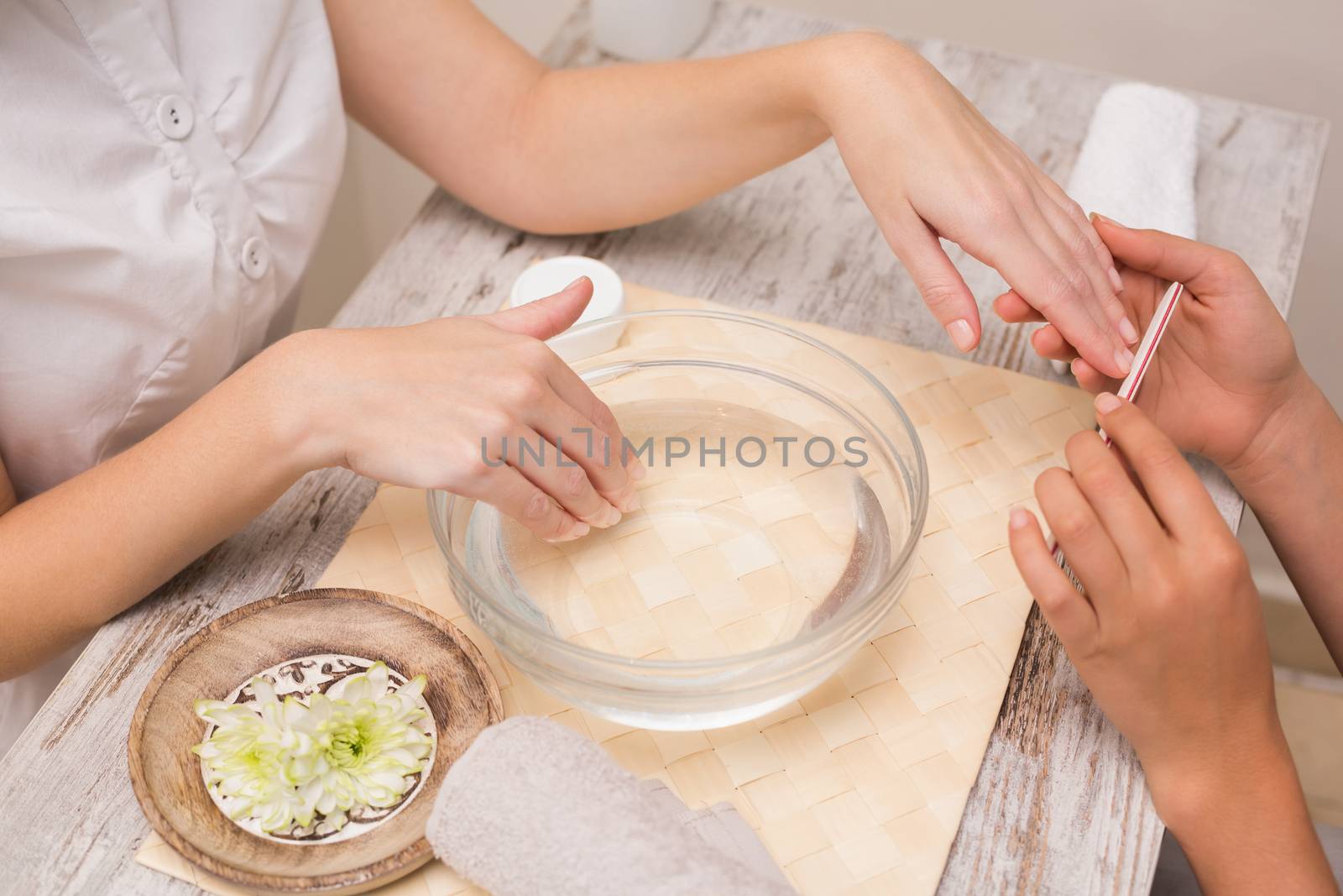 Nail technician giving customer a manicure by Wavebreakmedia