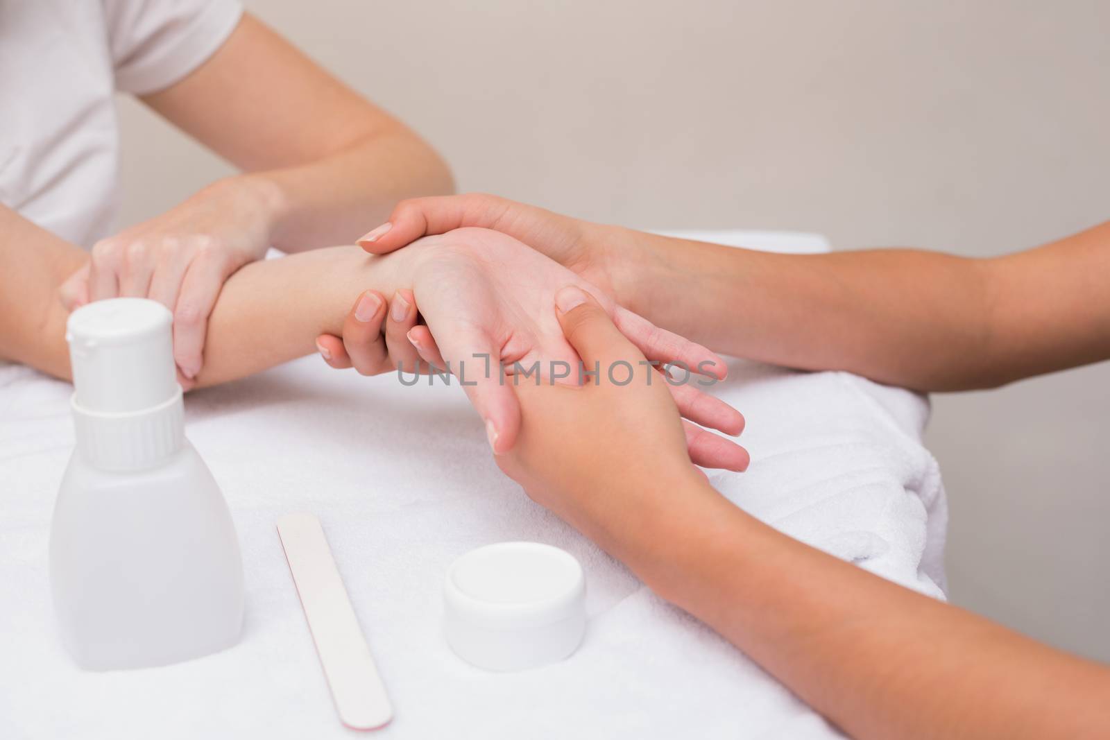 Woman getting a hand massage at the beauty salon