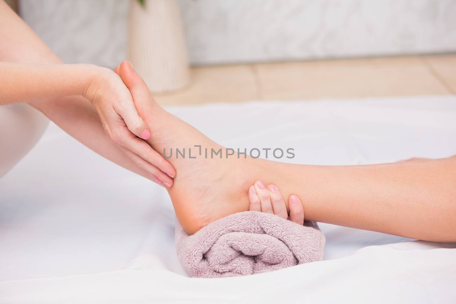 Woman receiving a foot massage by Wavebreakmedia