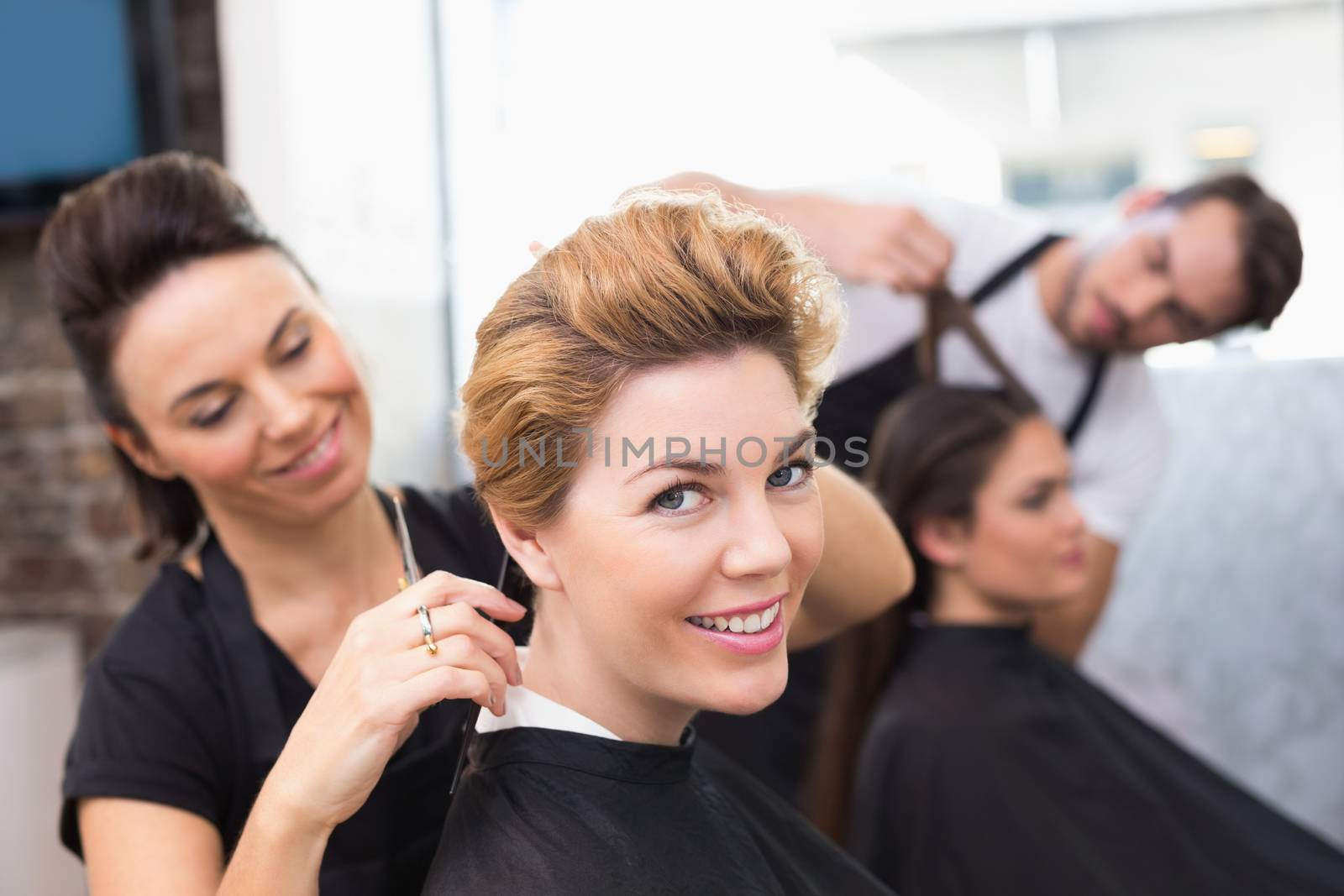 Hairdressers working on their clients at the hair salon