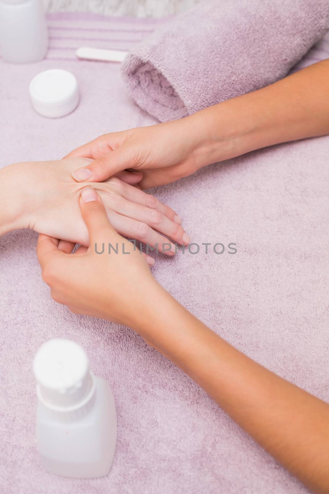 Woman getting a hand massage at the beauty salon