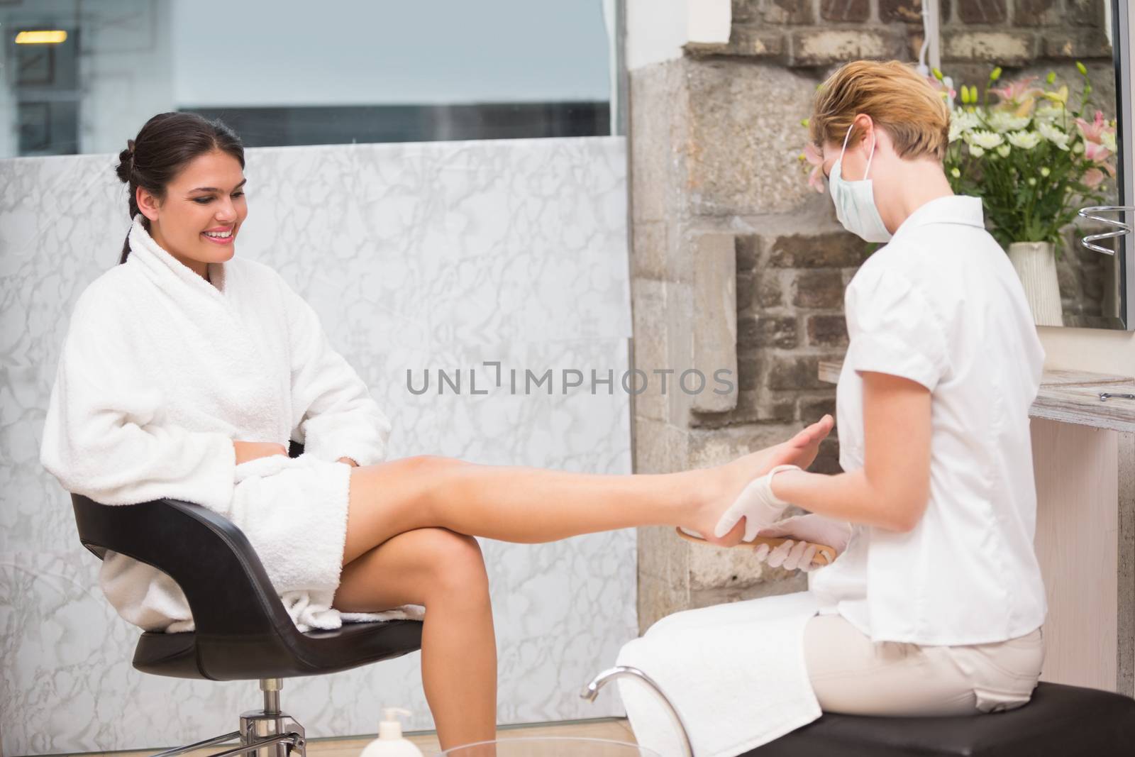 Woman getting a pedicure from beautician by Wavebreakmedia