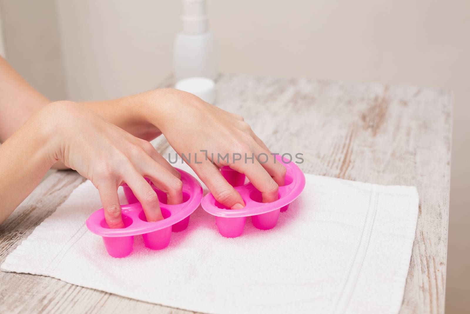 Woman soaking her nails in nail bowls by Wavebreakmedia