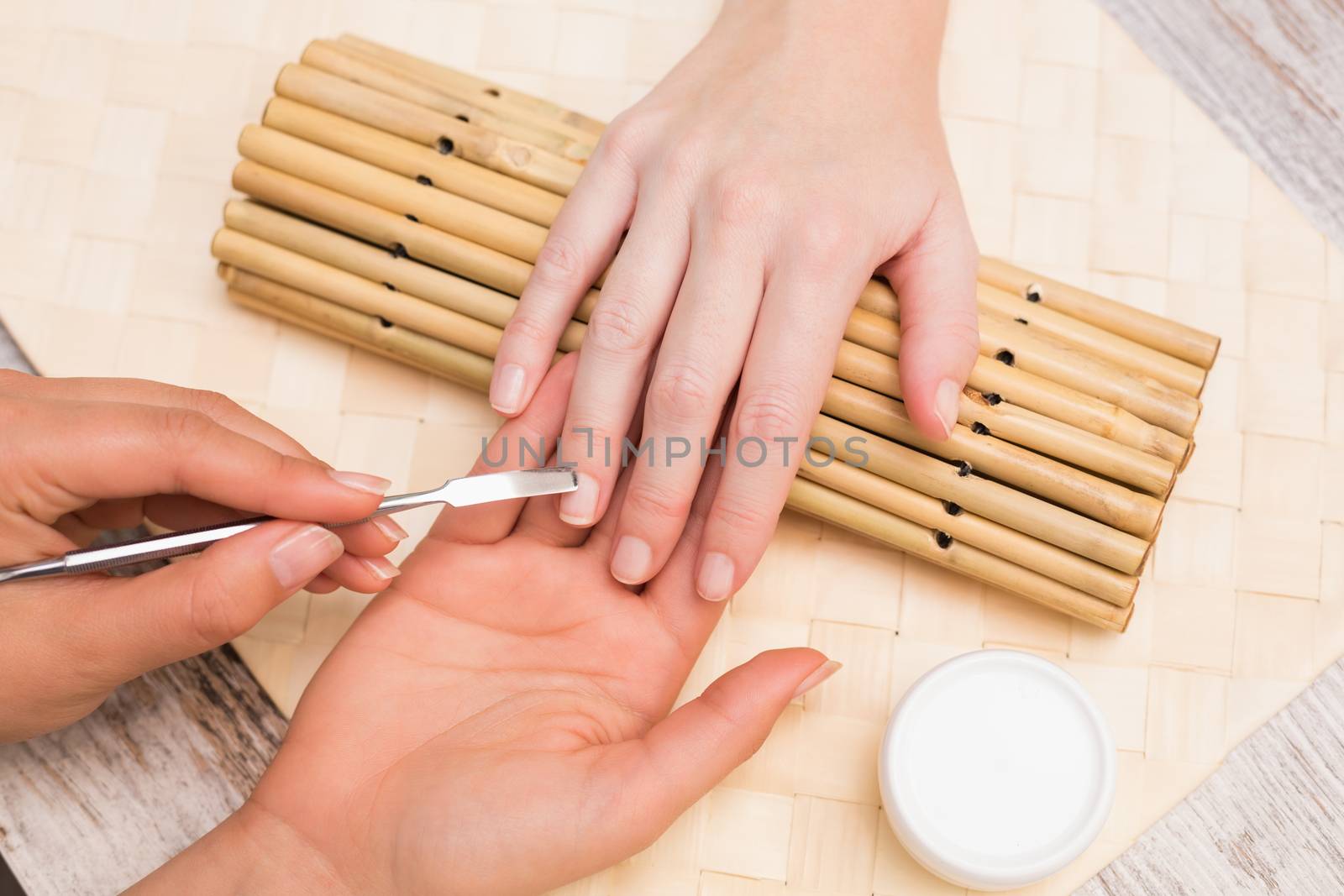 Nail technician giving customer a manicure by Wavebreakmedia
