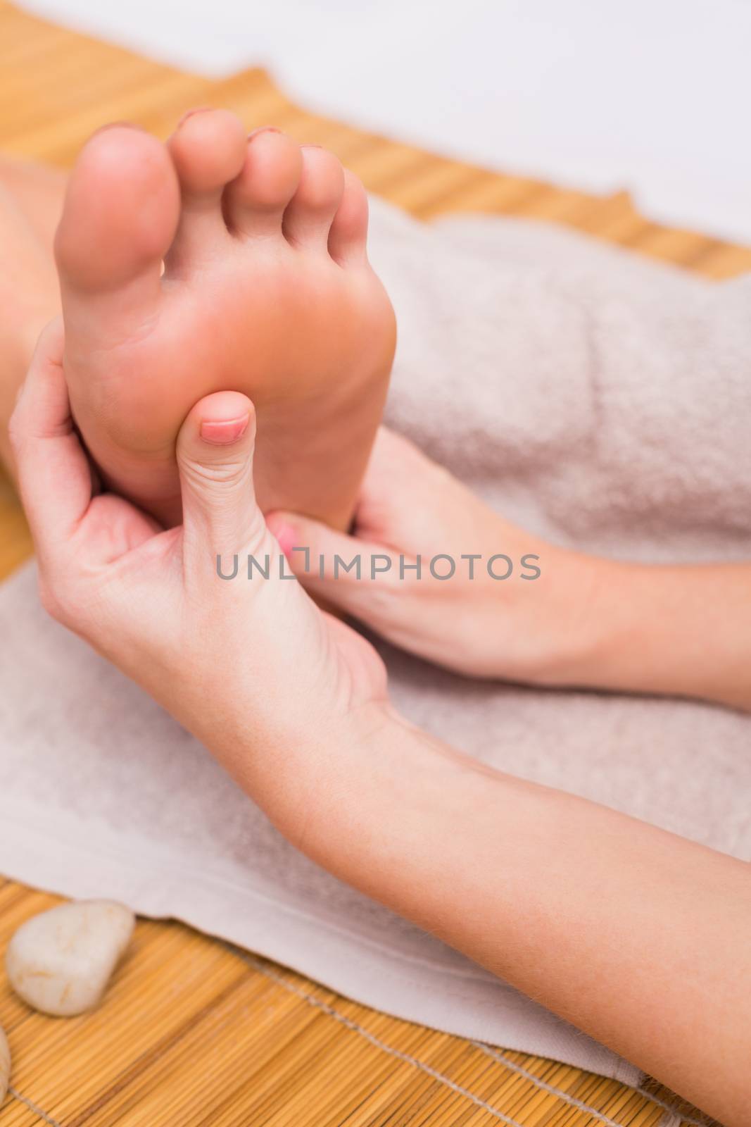 Woman receiving a foot massage  by Wavebreakmedia