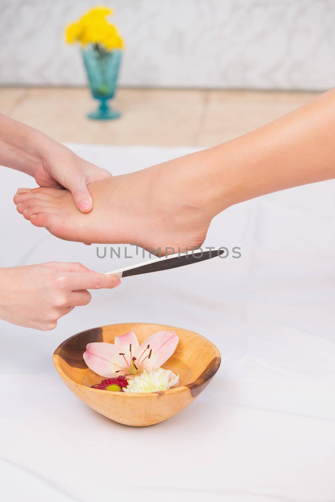 Woman getting a pedicure from beautician at the beauty salon