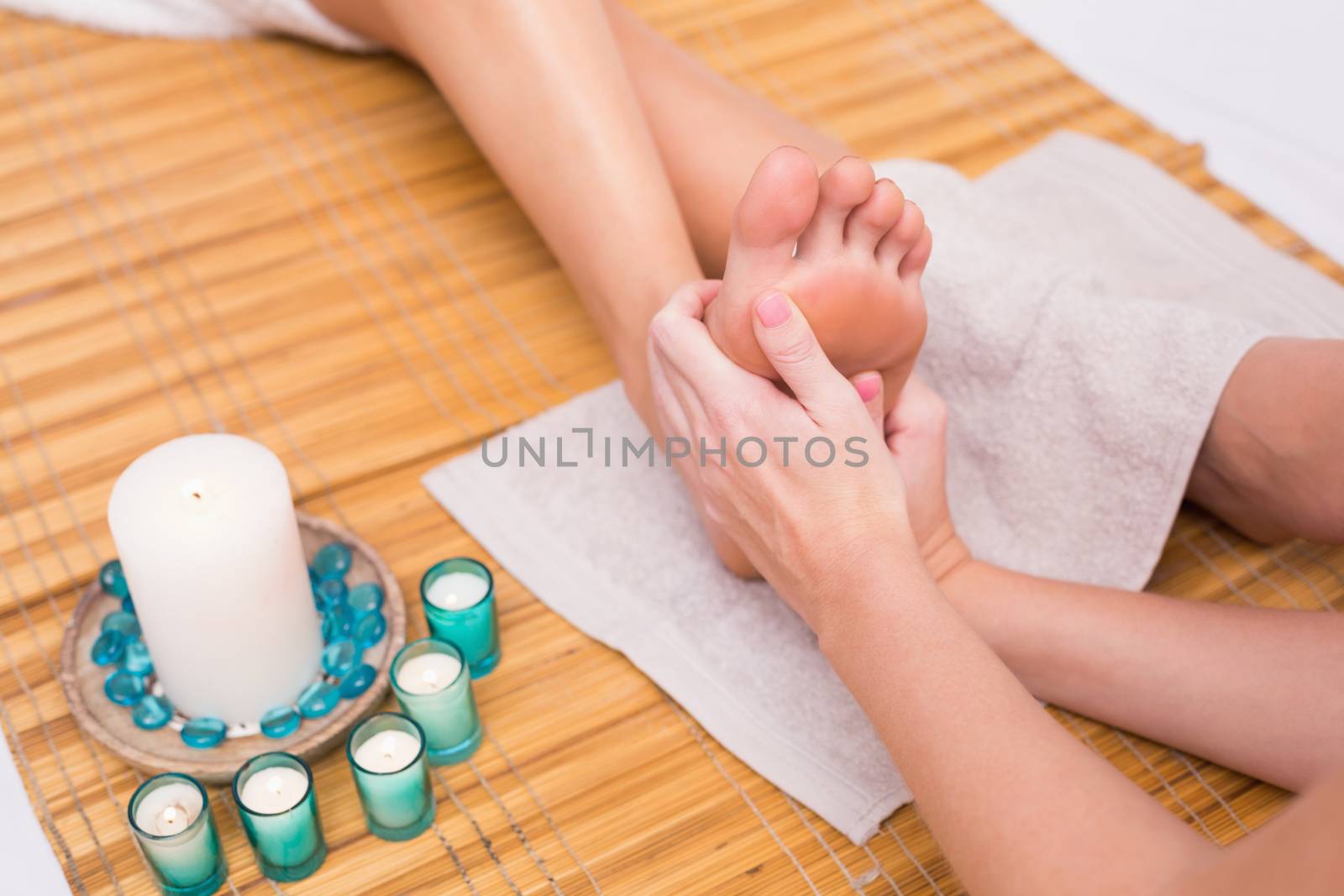 Woman receiving a foot massage  by Wavebreakmedia