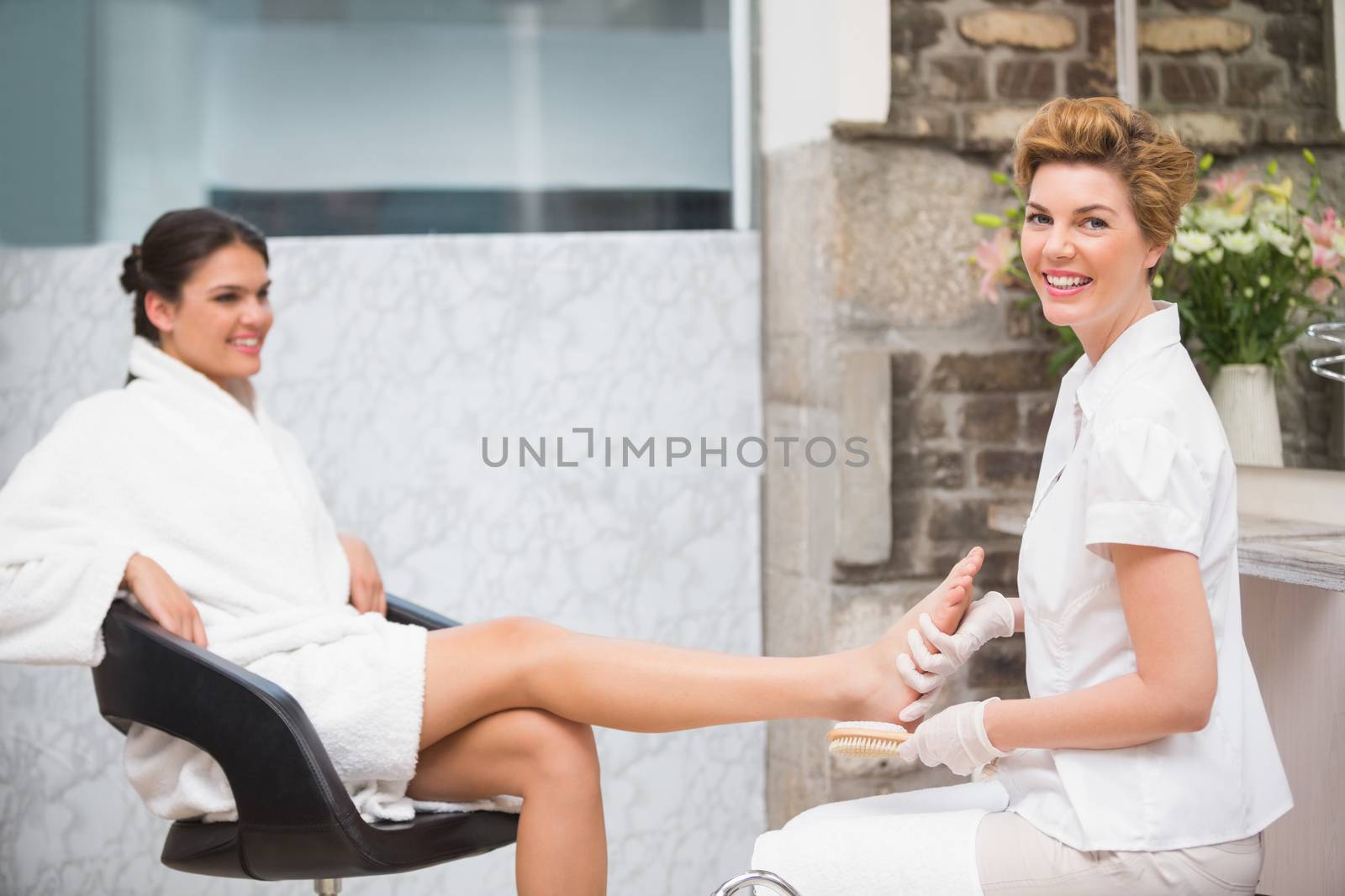 Woman getting a pedicure from beautician at the beauty salon