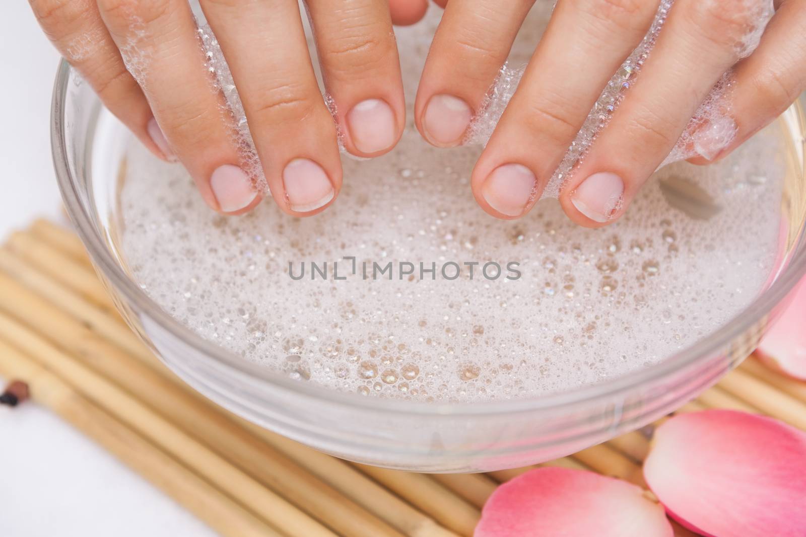 Customer washing their nails by Wavebreakmedia