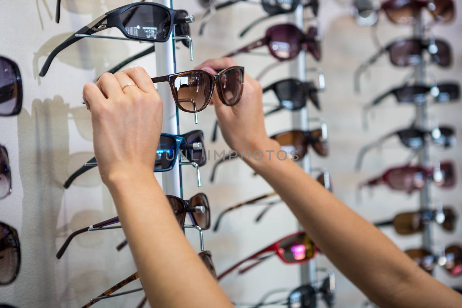 Woman picking out new sunglasses by Wavebreakmedia