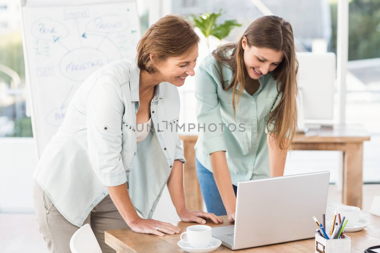 Casual businesswomen working with laptop by Wavebreakmedia