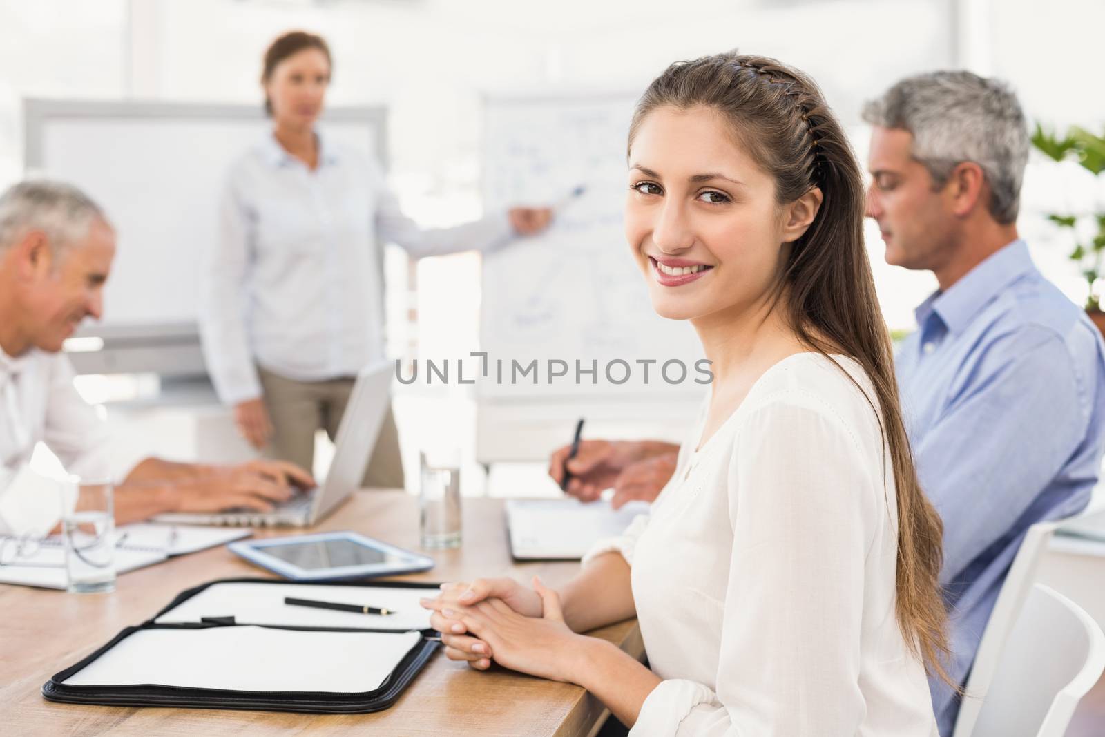 Portrait of smiling businesswoman during a presentation in the office