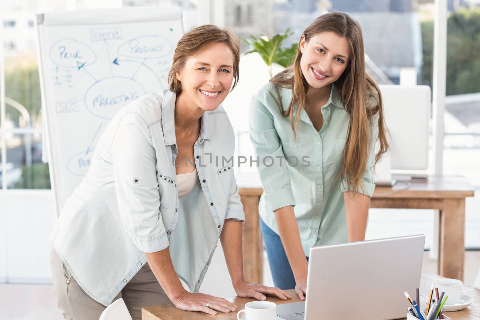 Portrait of casual businesswomen working with laptop