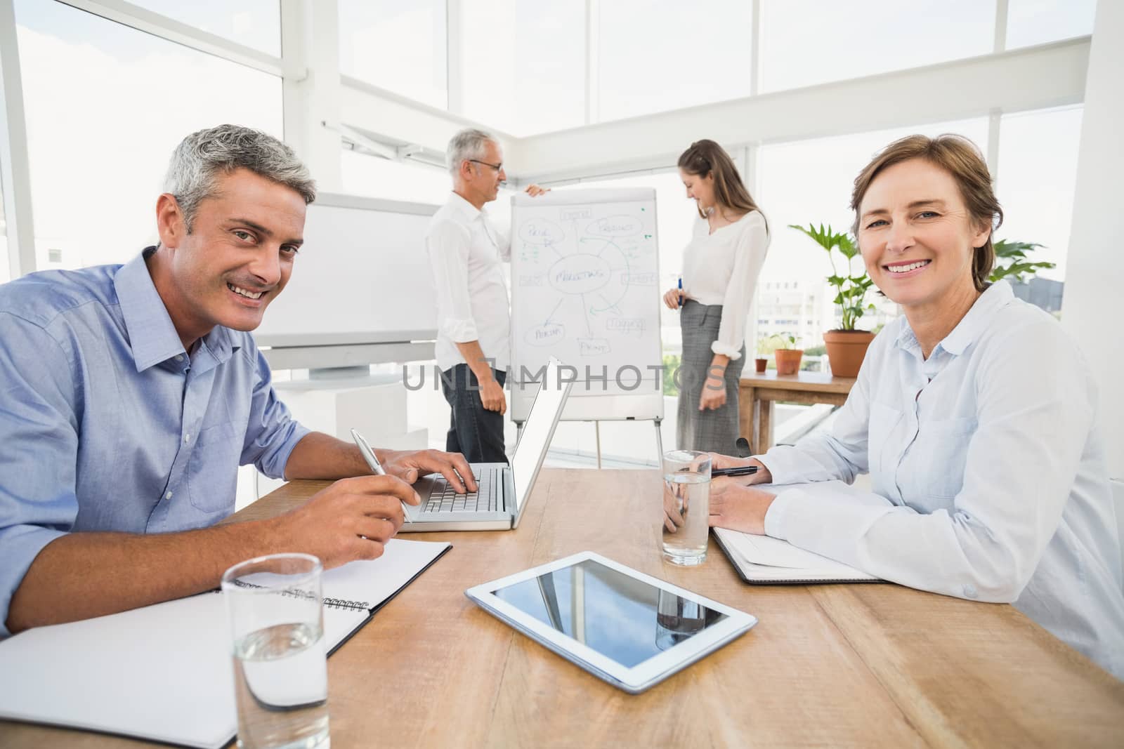 Portrait of smiling business people having a meeting in the office