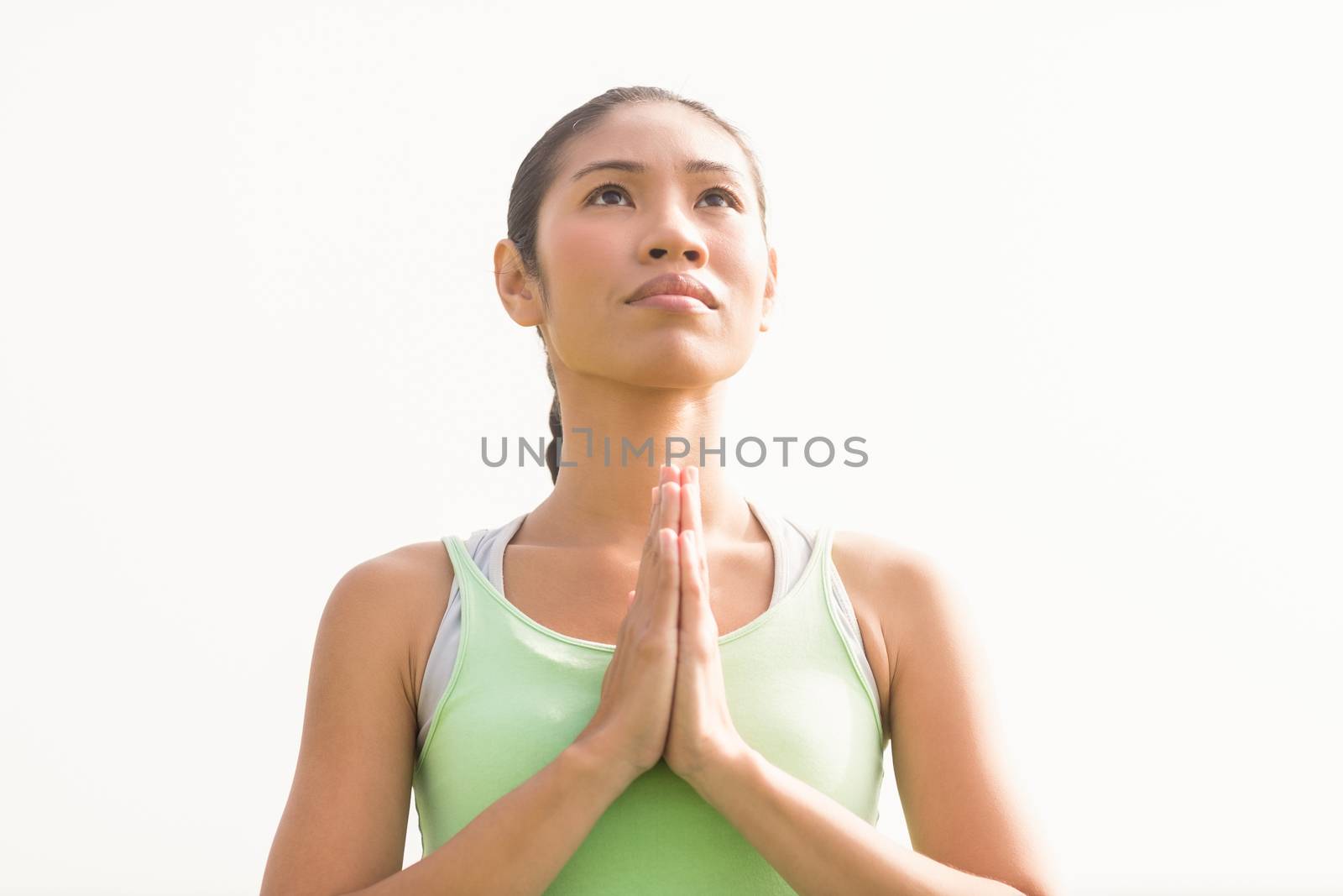 Focused sporty woman doing yoga in parkland