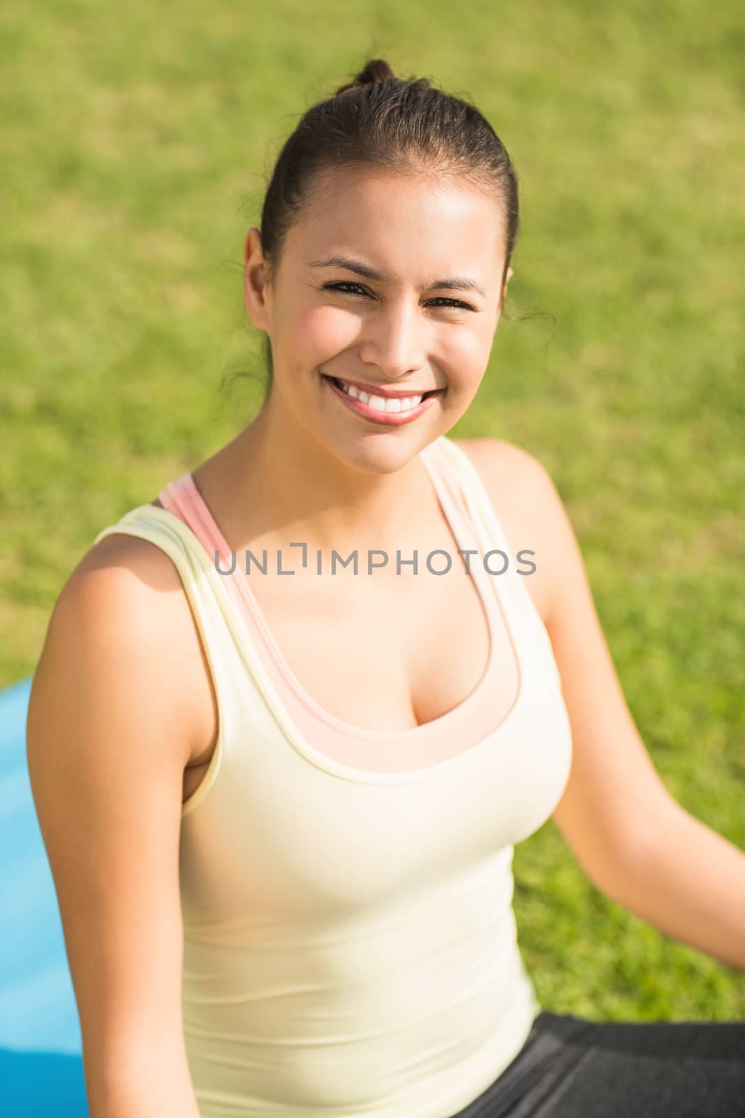 Portrait of smiling fit woman looking at camera in parkland