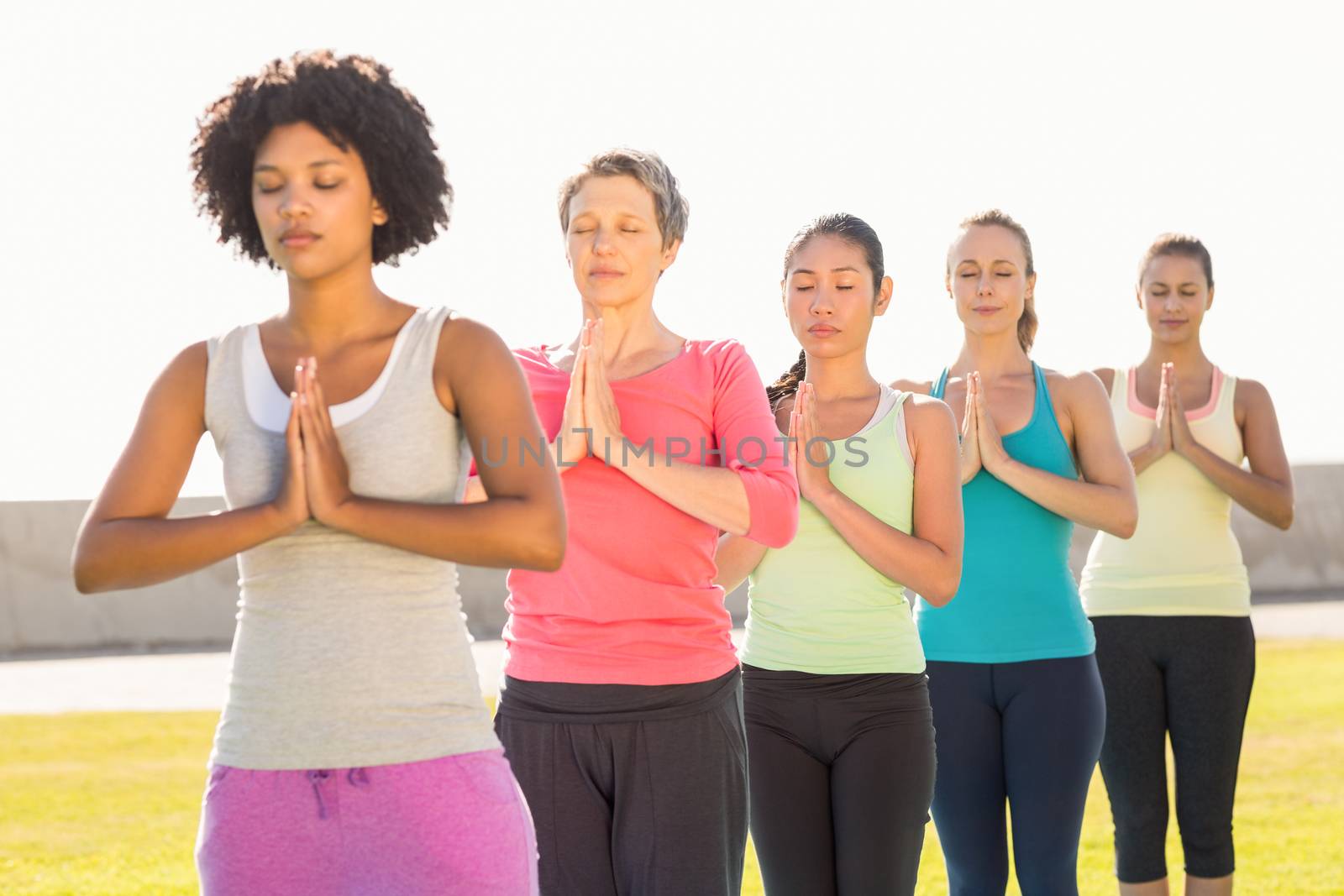 Peaceful sporty women doing prayer position in yoga class by Wavebreakmedia