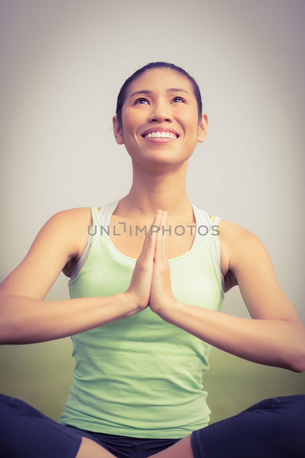 Smiling sporty woman doing yoga in parkland