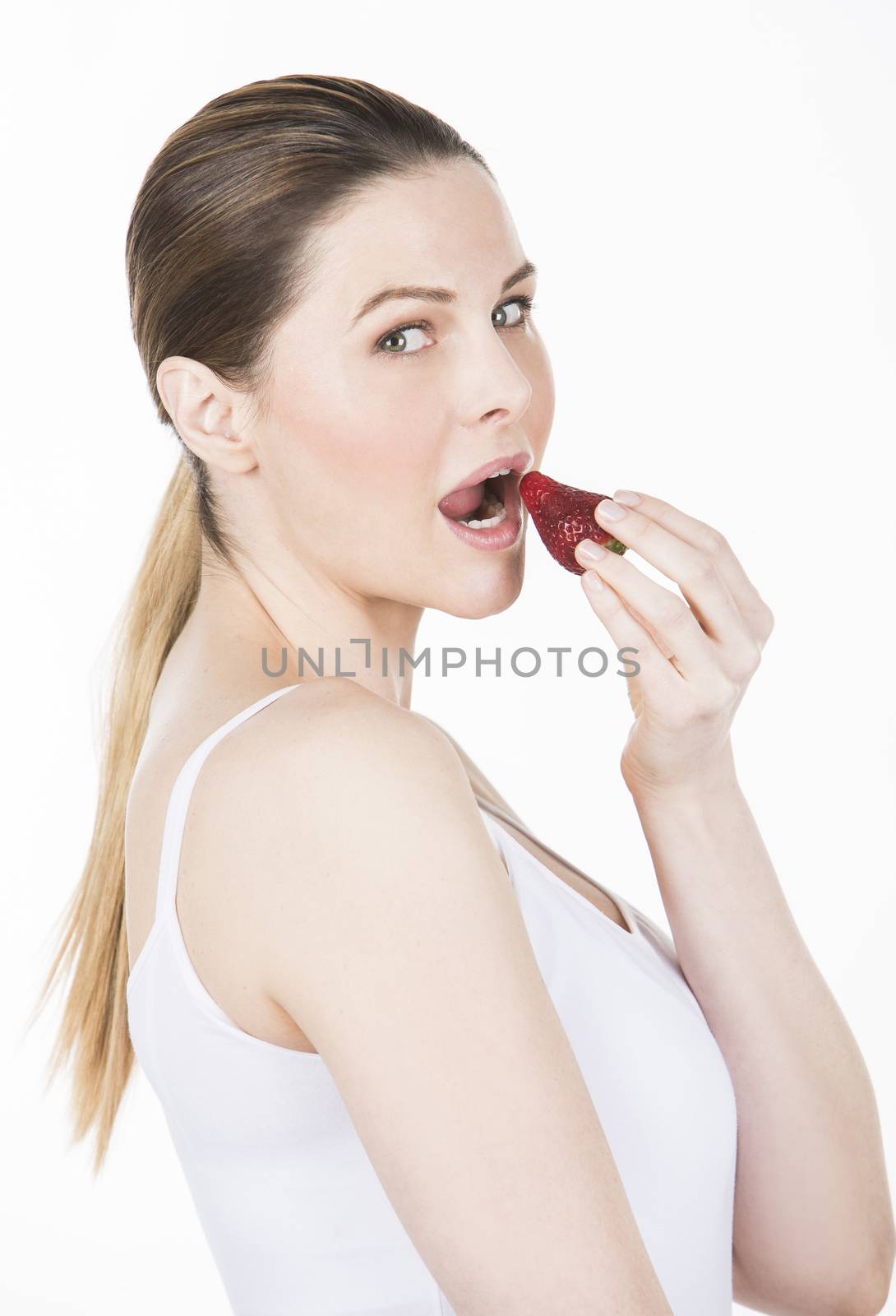 woman with white dress eating a strawberry by Flareimage