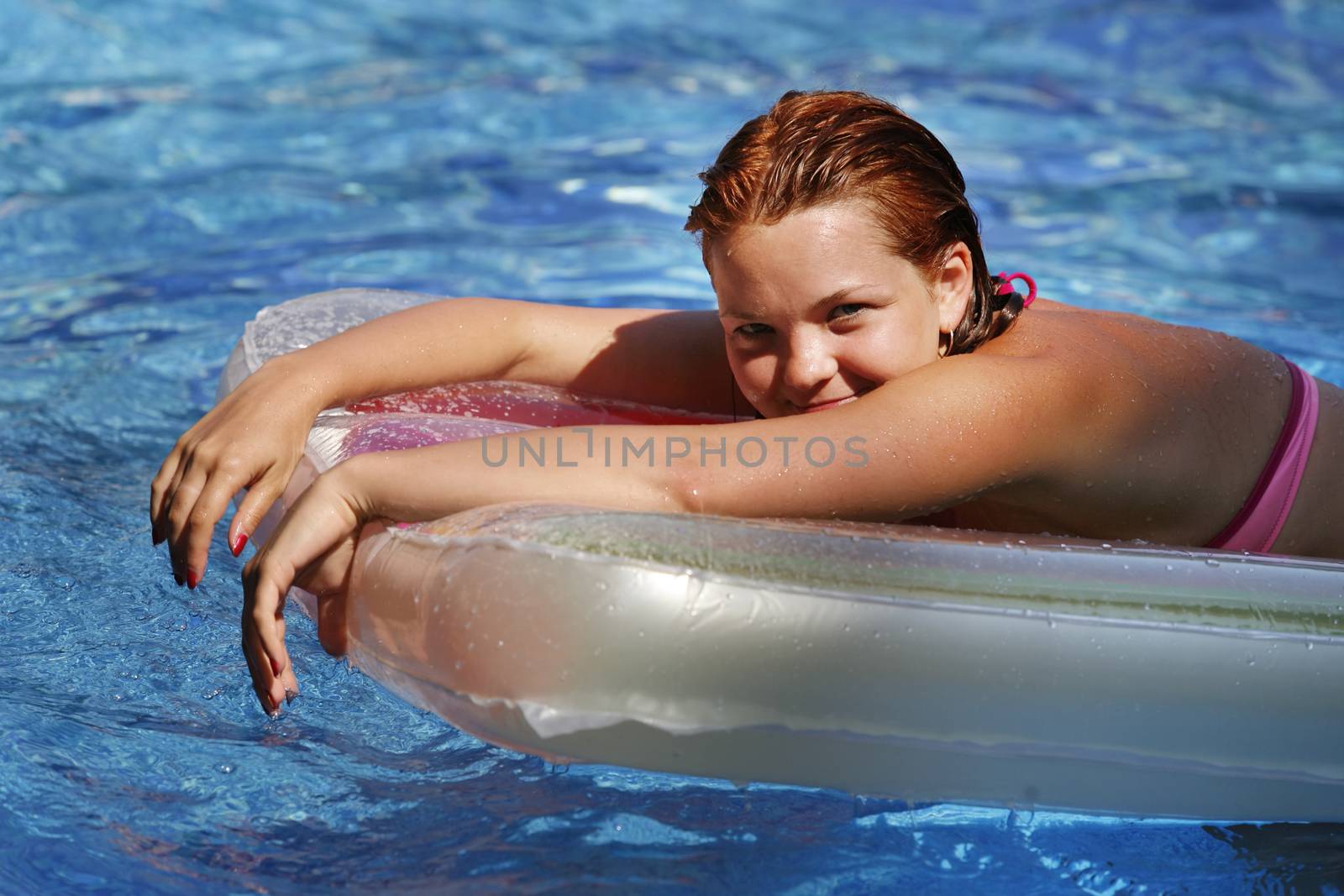 Beautiful woman enjoying summer in the pool