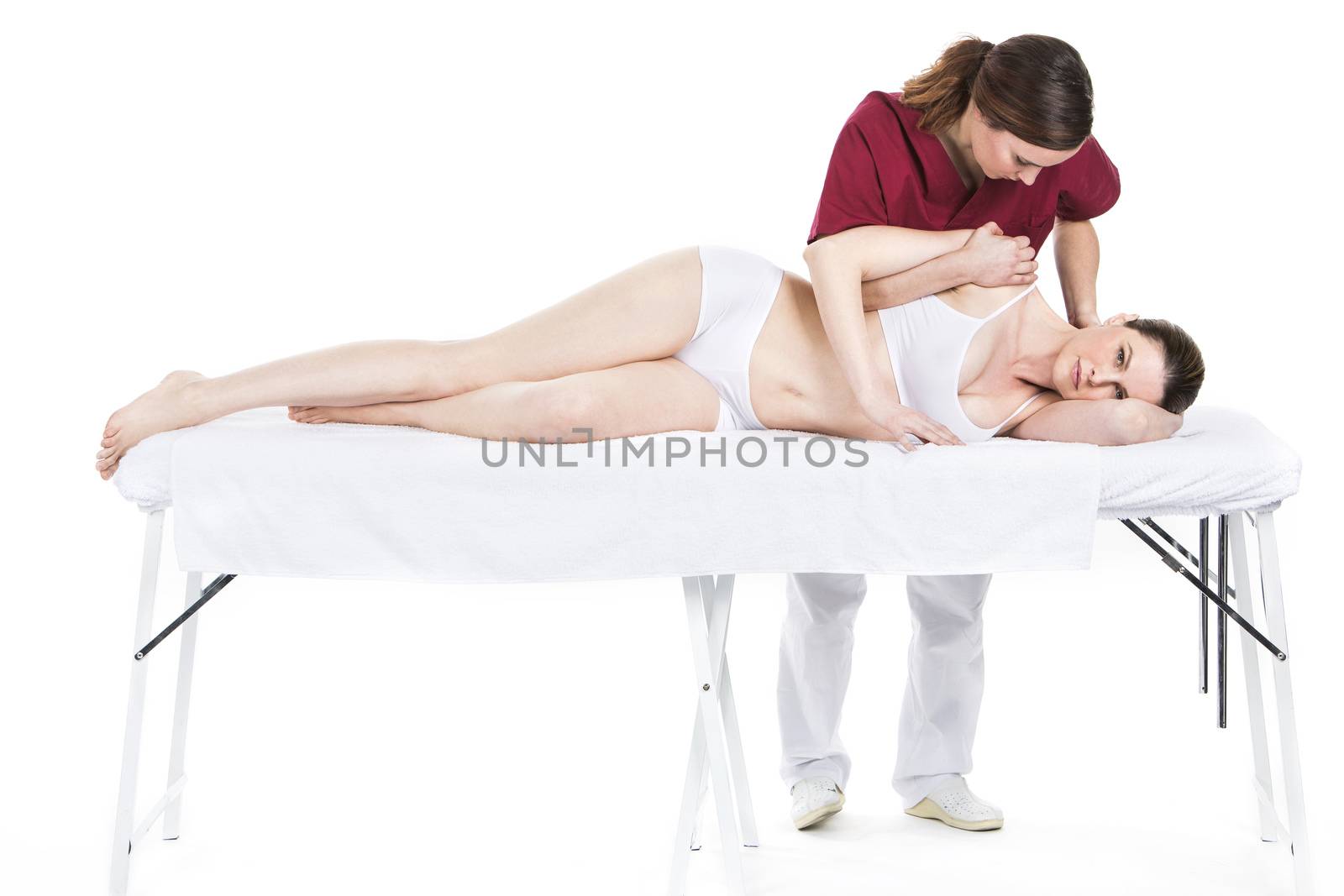physiotherapist with woman patient by Flareimage