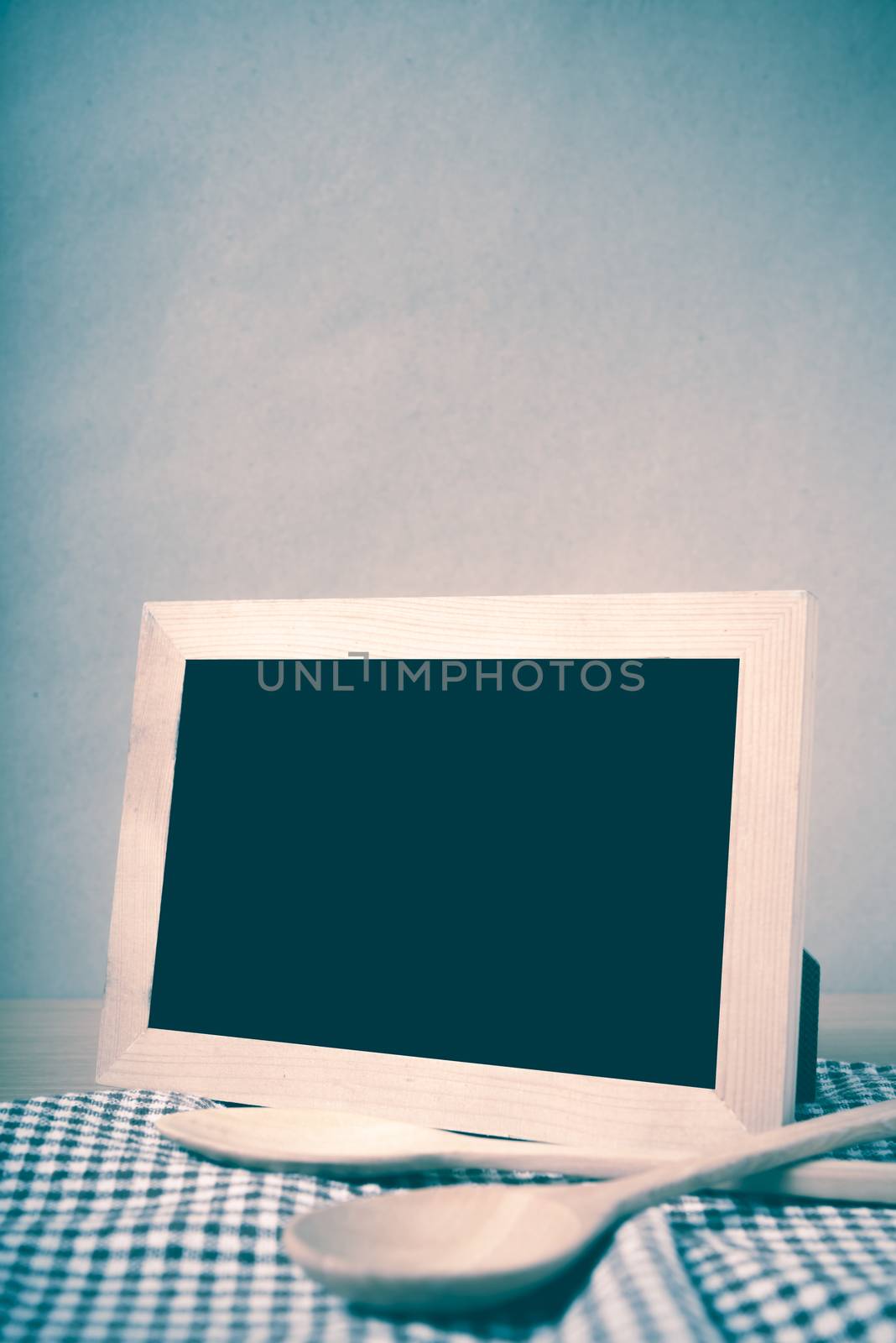 blackboard and wooden spoon on table vintage style