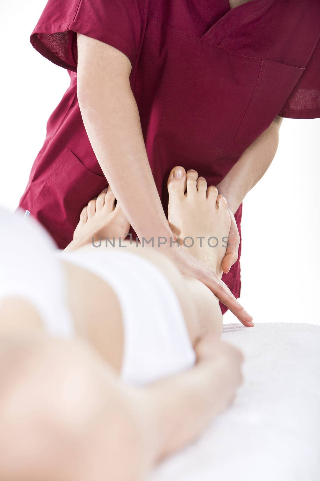 physical therapist reflexology to a woman pati by Flareimage