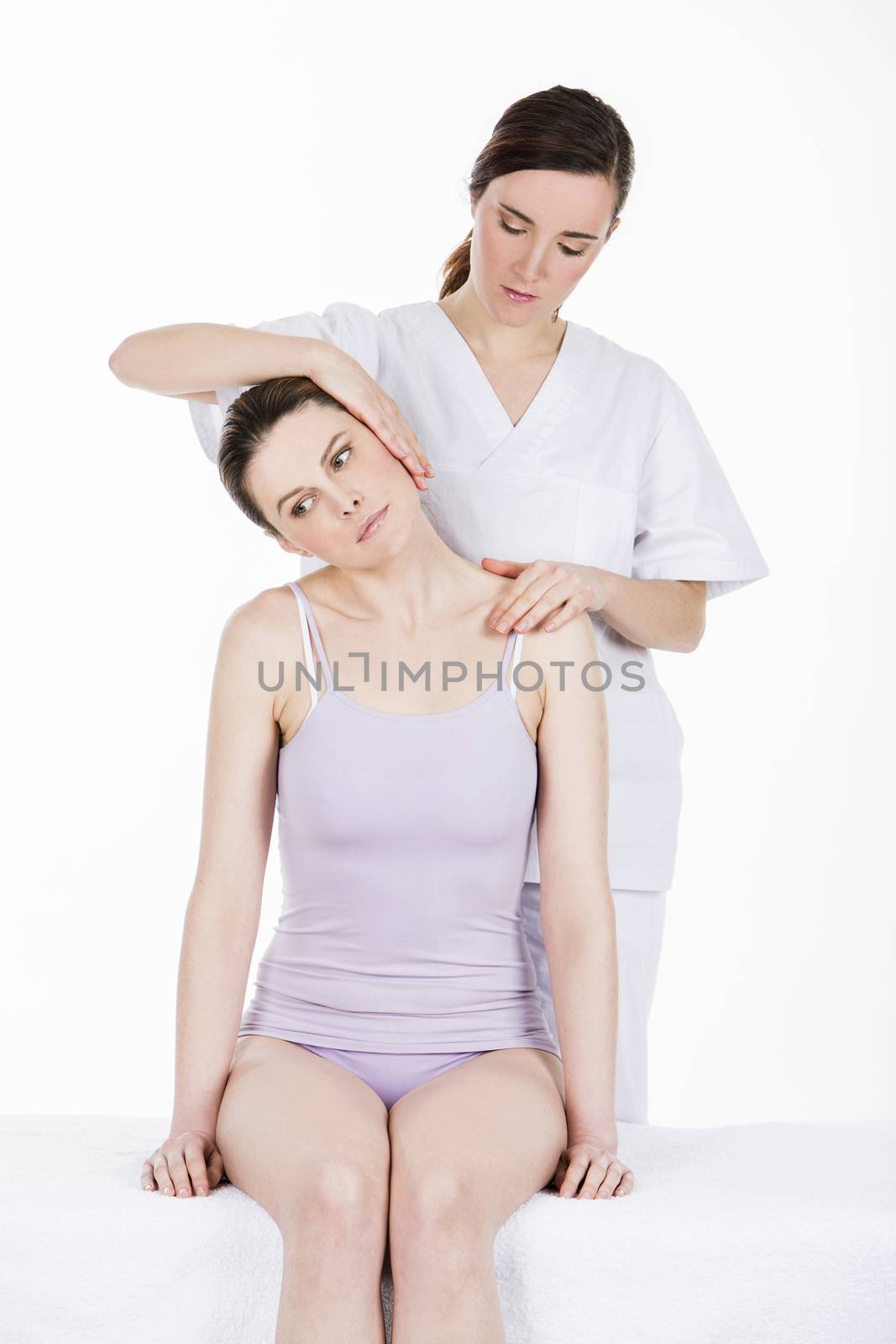 physical therapist gives massage to woman neck