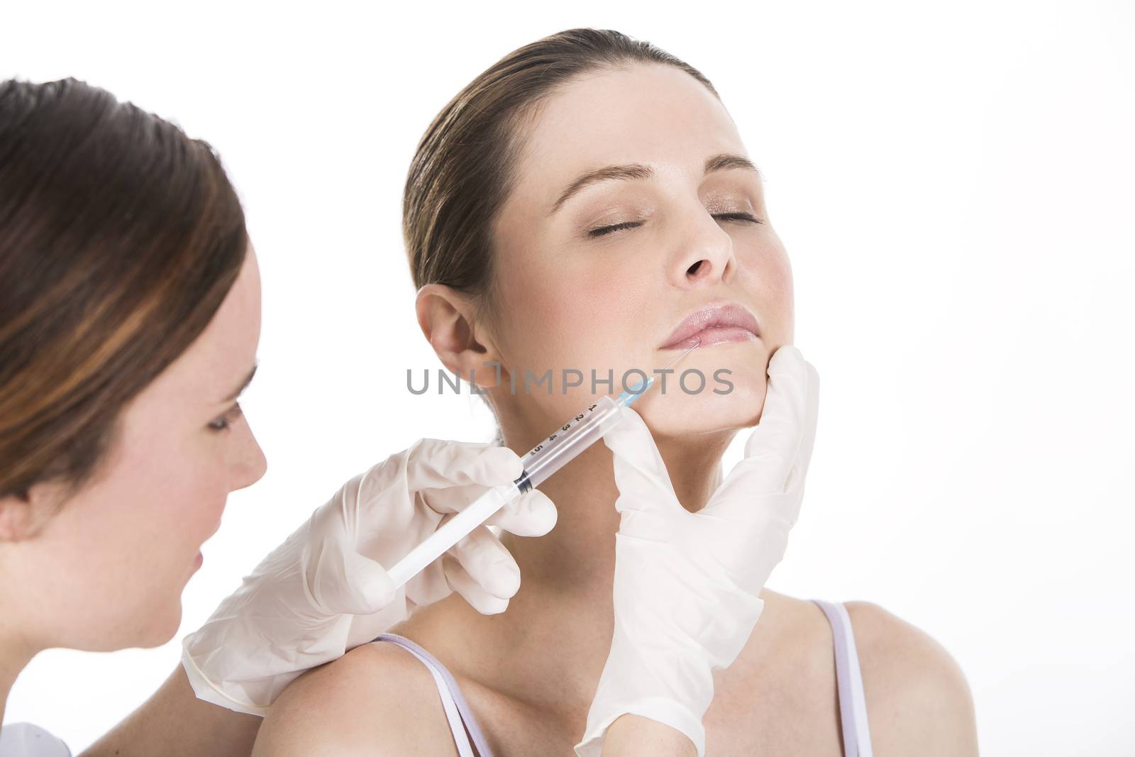 doctor doing  botox injection to a woman by Flareimage