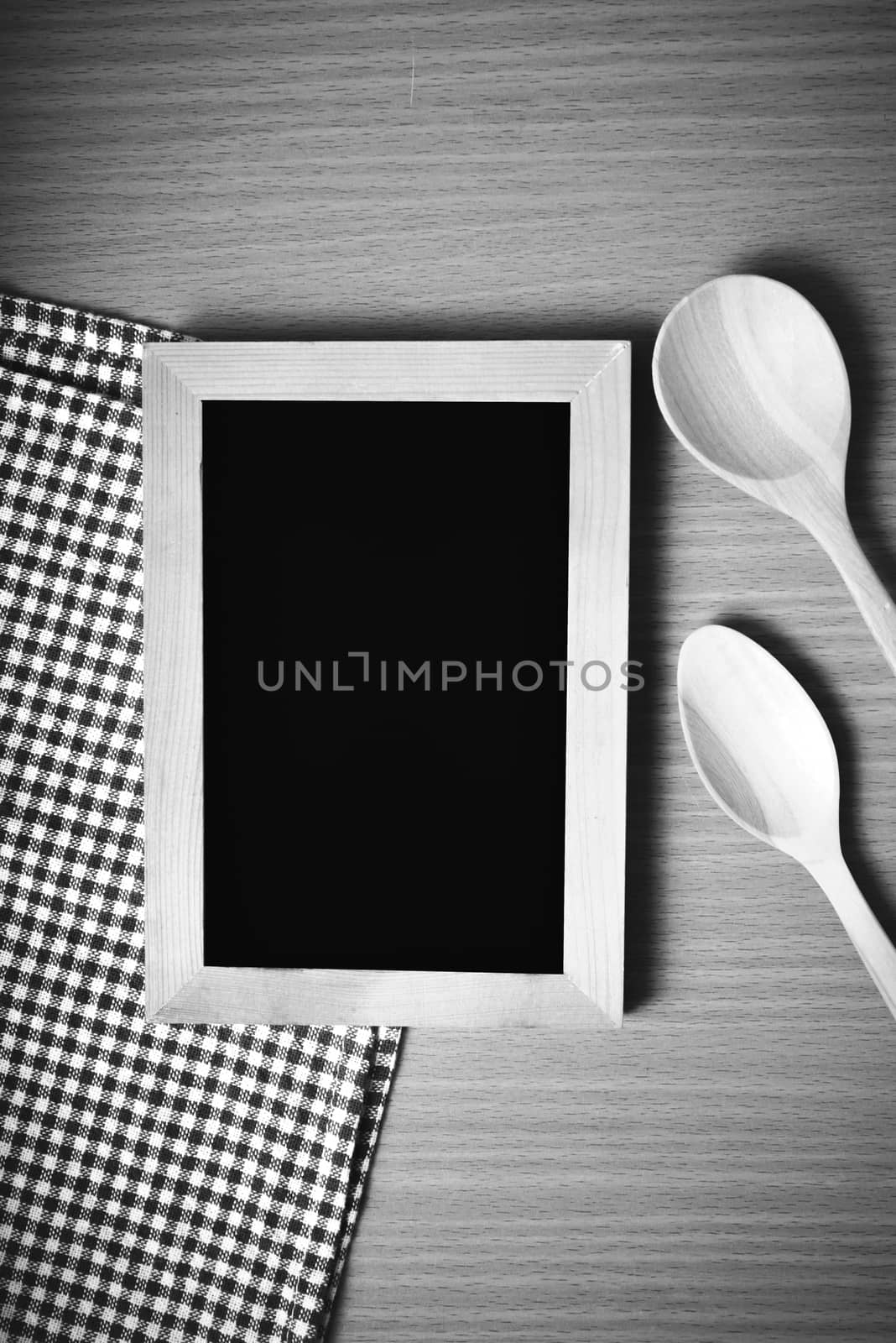 blackboard and wooden spoon on table black and white color tone style