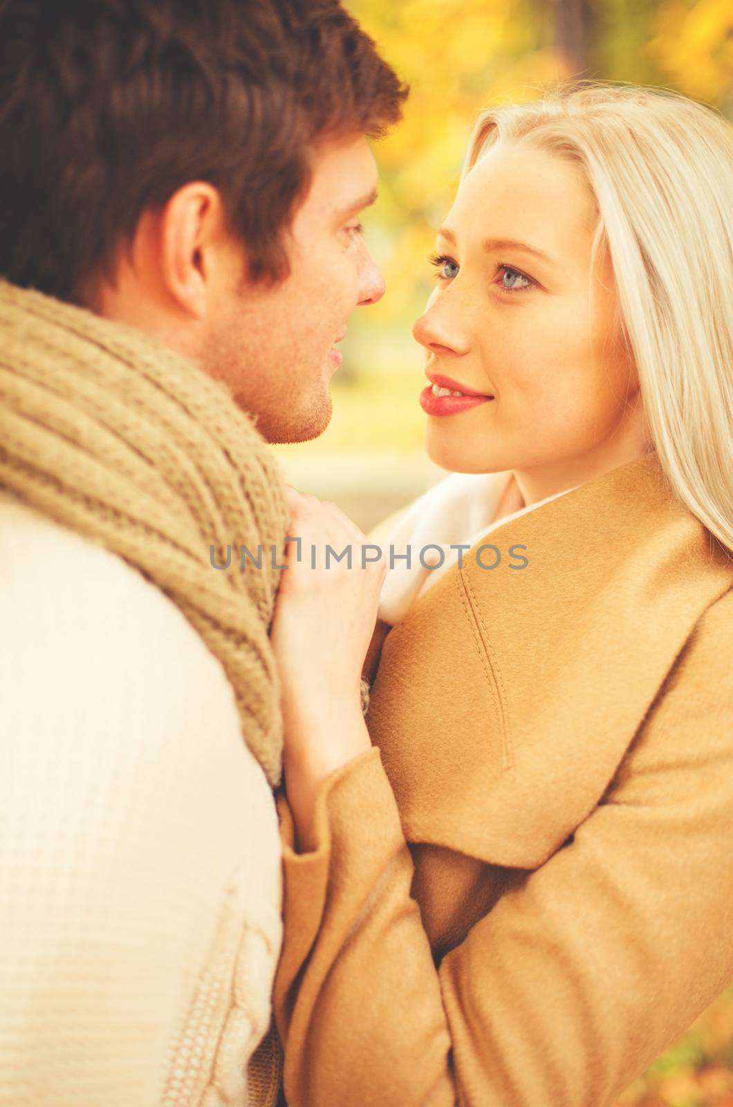 romantic couple kissing in the autumn park by dolgachov