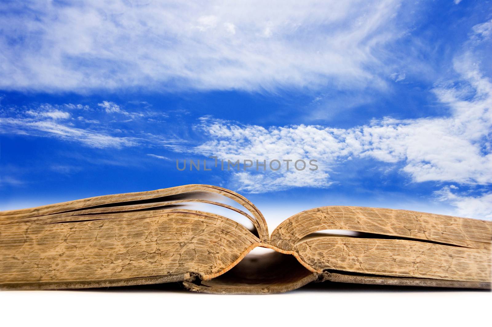 Book conceptual image. Open book against blue sky.