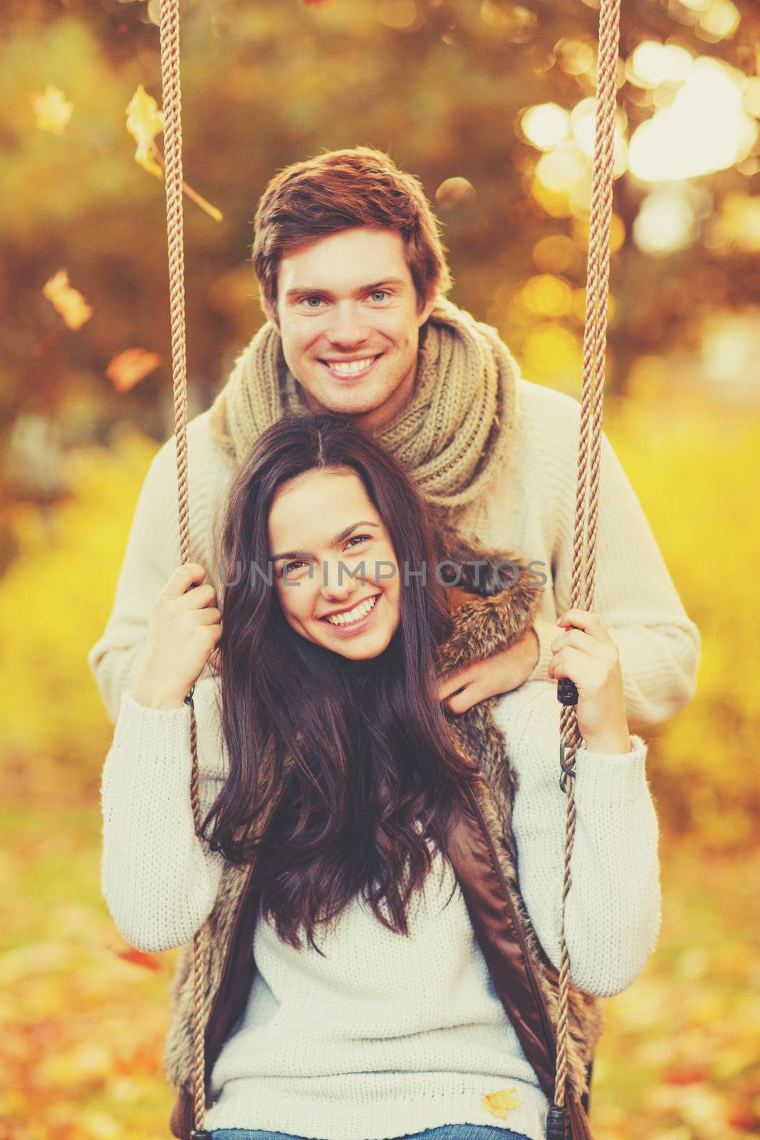 holidays, love, relationship and dating concept - romantic couple in the autumn park