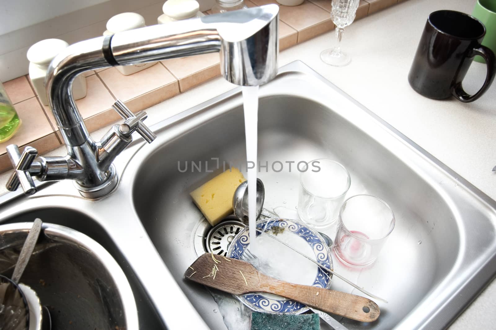 Kitchen conceptual image. Dirty sink with many dirty dishes.