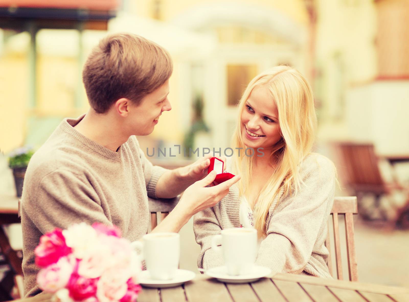 summer holidays, love, relationship and dating concept - romantic man proposing to beautiful woman