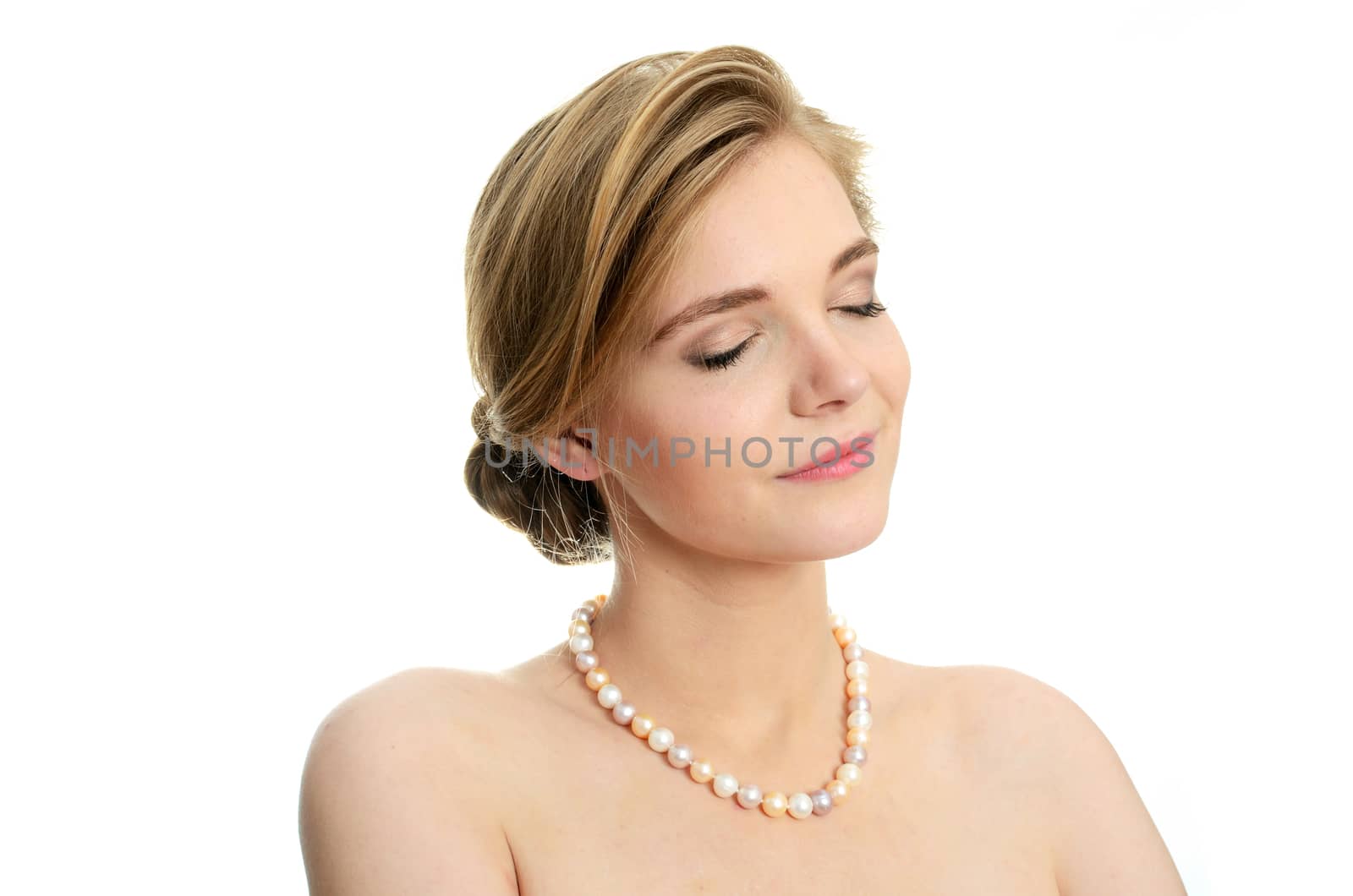 Beautiful female model with pearls on her neck. Portrait of young girl with closed eyes.