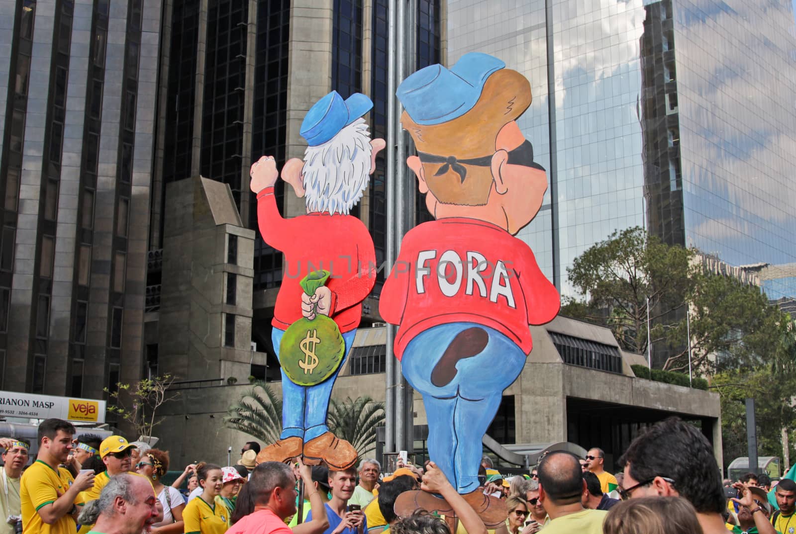SAO PAULO, BRAZIL August 16 2015: An unidentified group of people with flags and yellow and green clothes in the protest against federal government corruption in Sao Paulo Brazil.