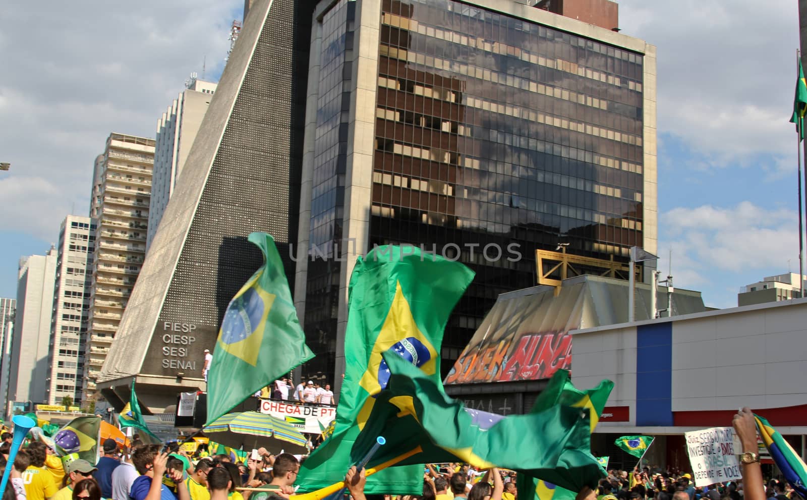 SAO PAULO, BRAZIL August 16 2015: An unidentified group of people with flags and yellow and green clothes in the protest against federal government corruption in Sao Paulo Brazil.