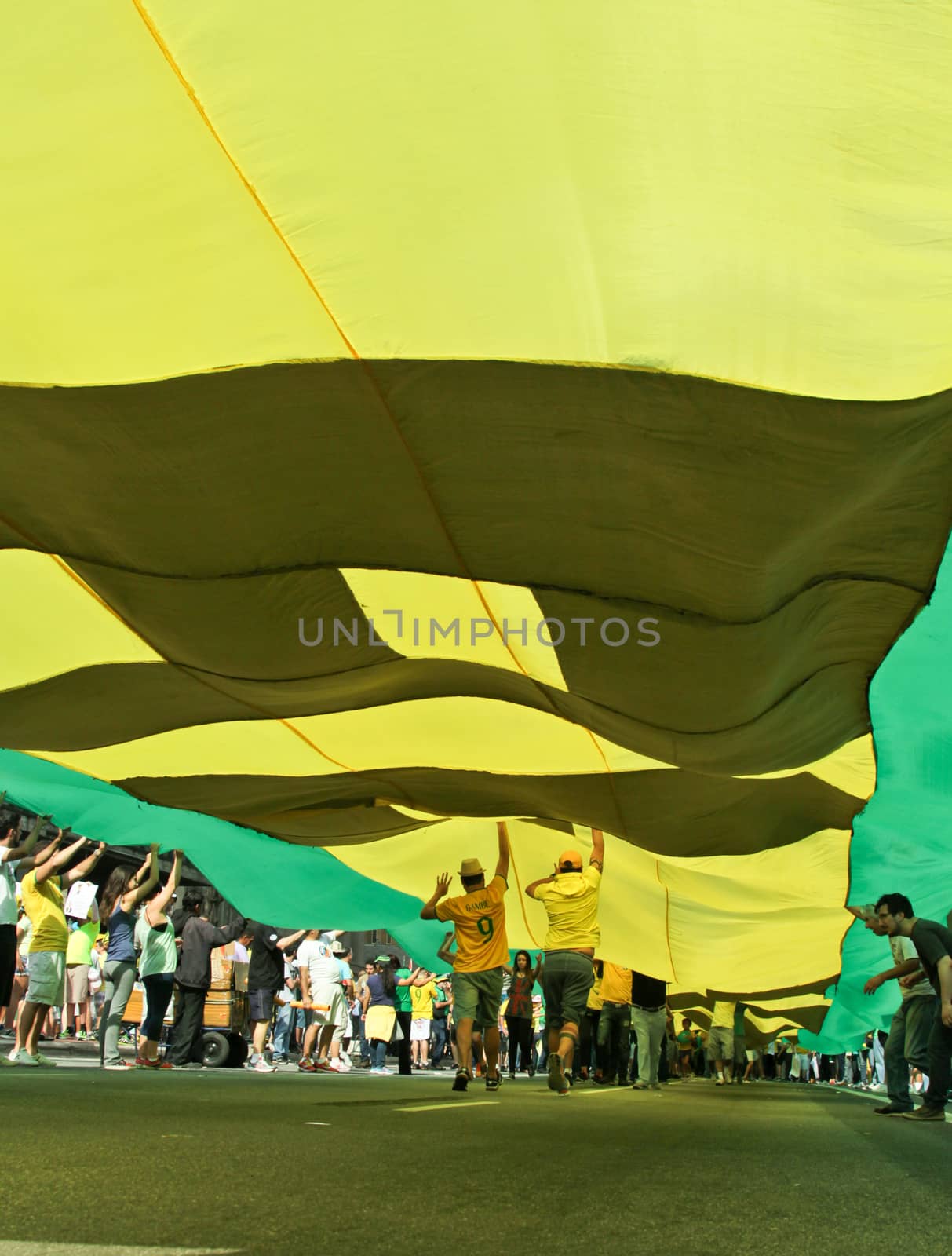 SAO PAULO, BRAZIL August 16, 2015: An unidentified group of people hold a big flag in the protest against federal government corruption in Sao Paulo Brazil. Protesters call for the impeachment of President Dilma Rousseff.