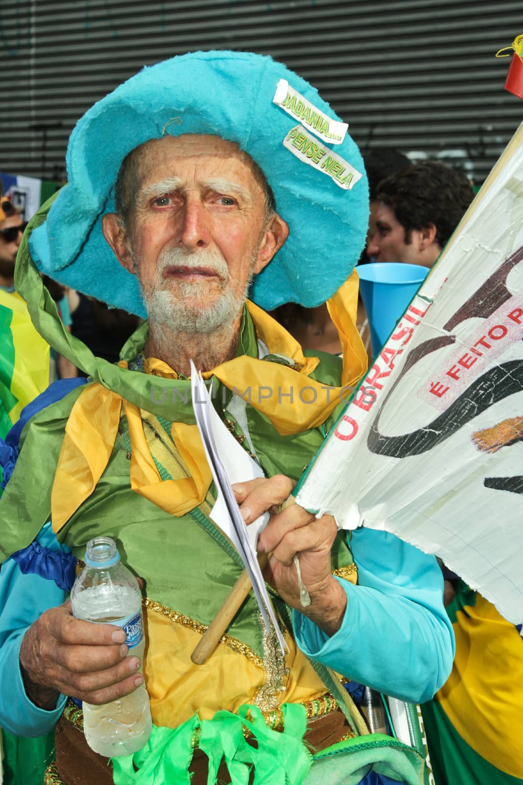 SAO PAULO, BRAZIL August 16, 2015: An unidentified man with yellow green and blue costume in the protest against federal government corruption in Sao Paulo Brazil. Protesters call for the impeachment of President Dilma Rousseff.