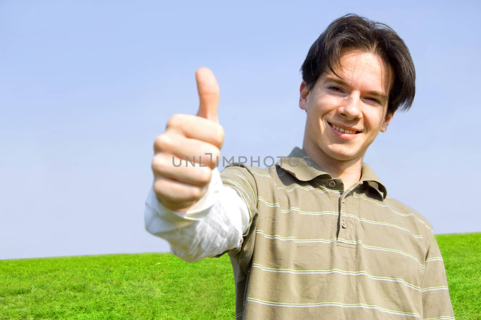 Gesture conceptual image. Teenager giving the thumbs-up sign.