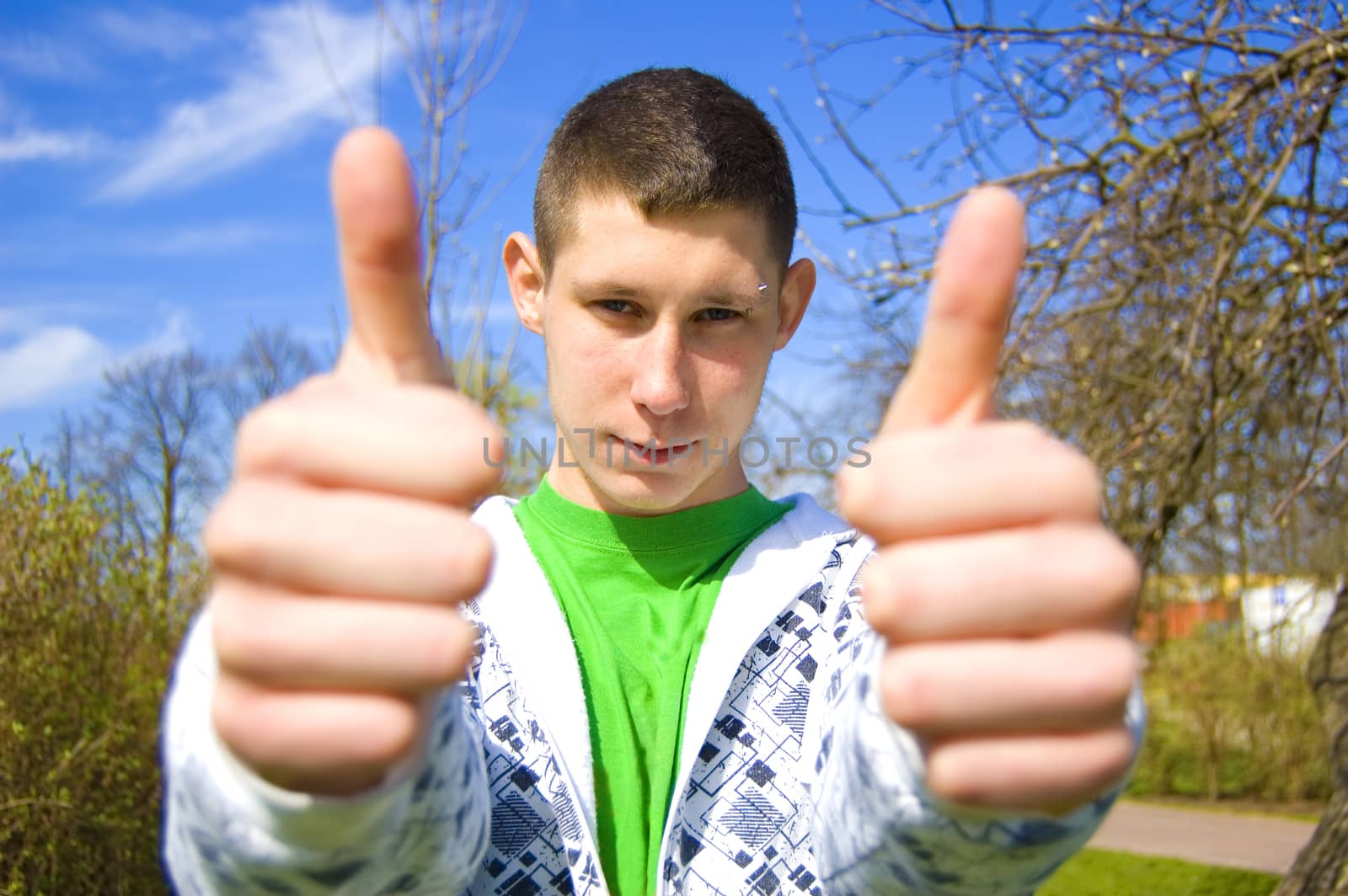 Teenager conceptual image. Teenager giving the thumbs-up signs.