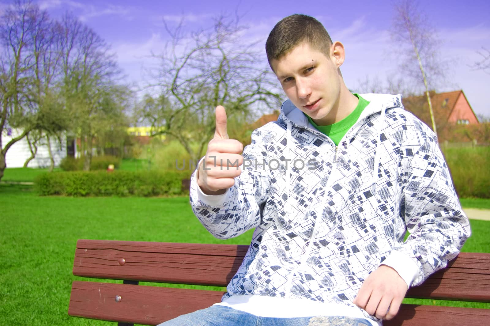 Teenager conceptual image. Teenager giving the thumbs-up sign.