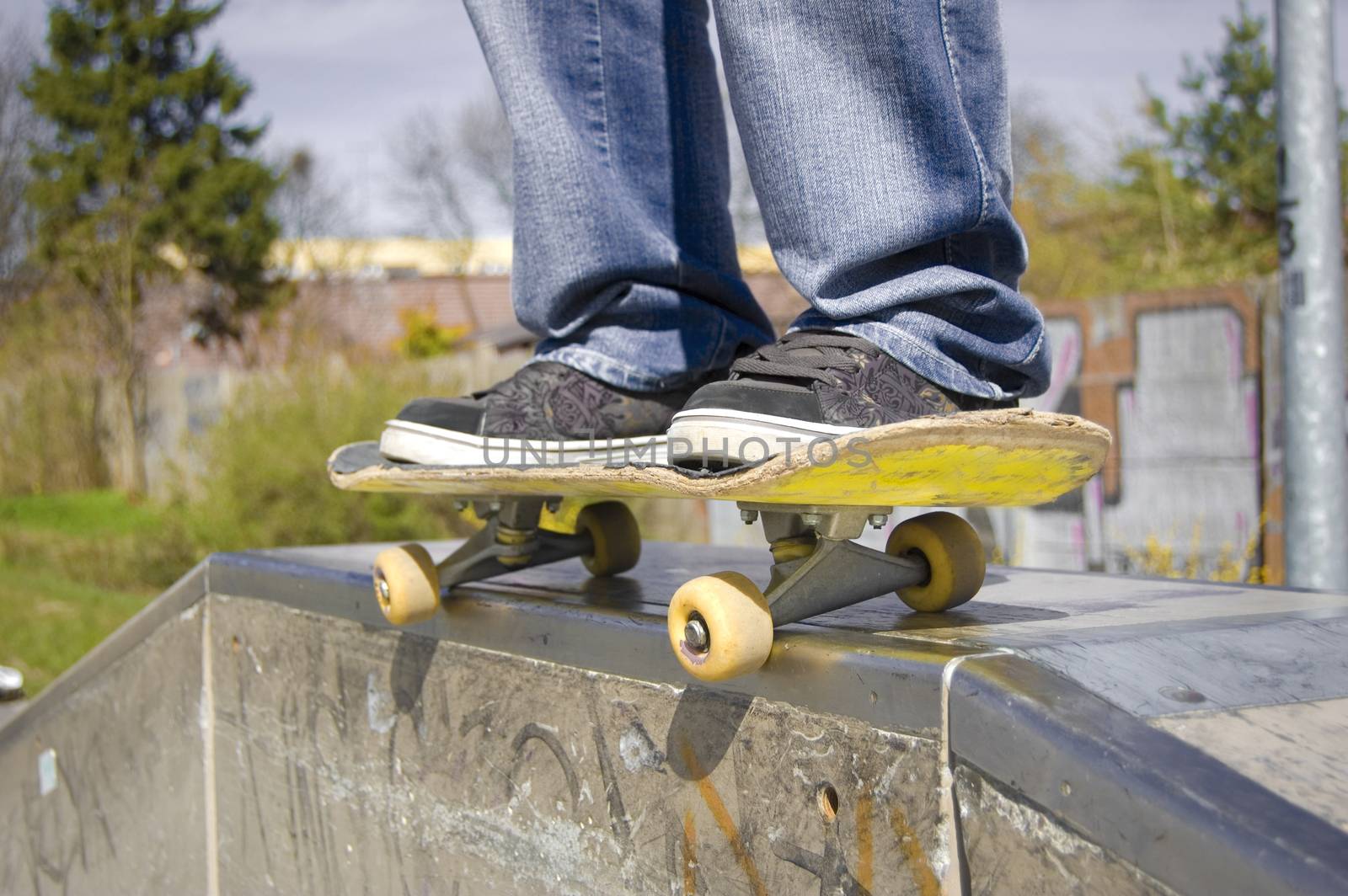 Skateboarder doing a slide. Picture of skateborad.