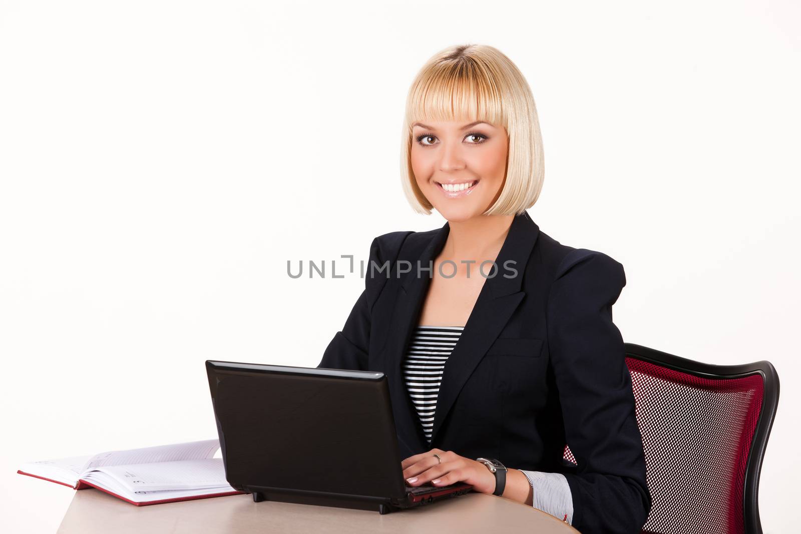 Young blonde woman with computer on a studio isolated background