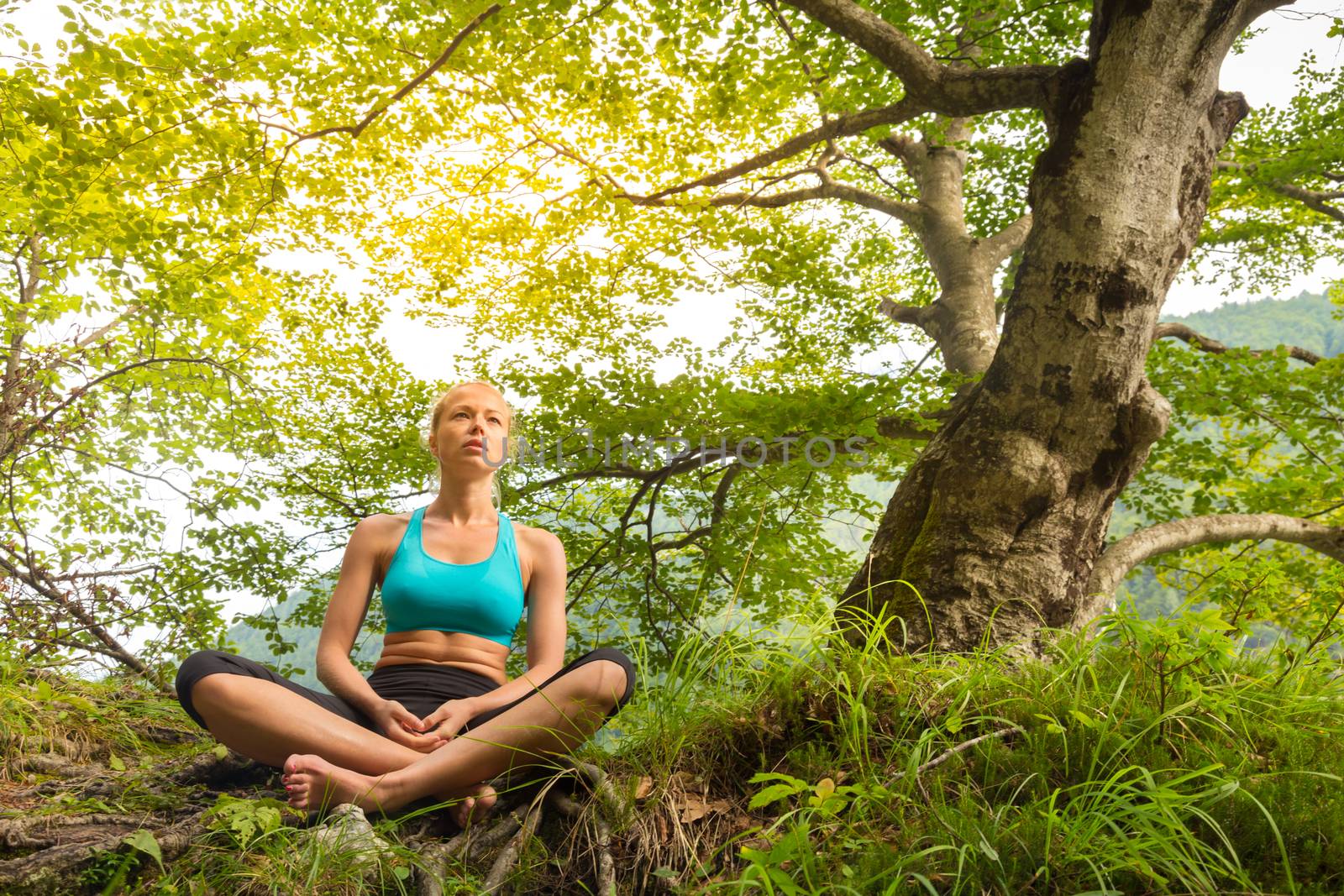 Woman relaxing in beautiful nature. by kasto