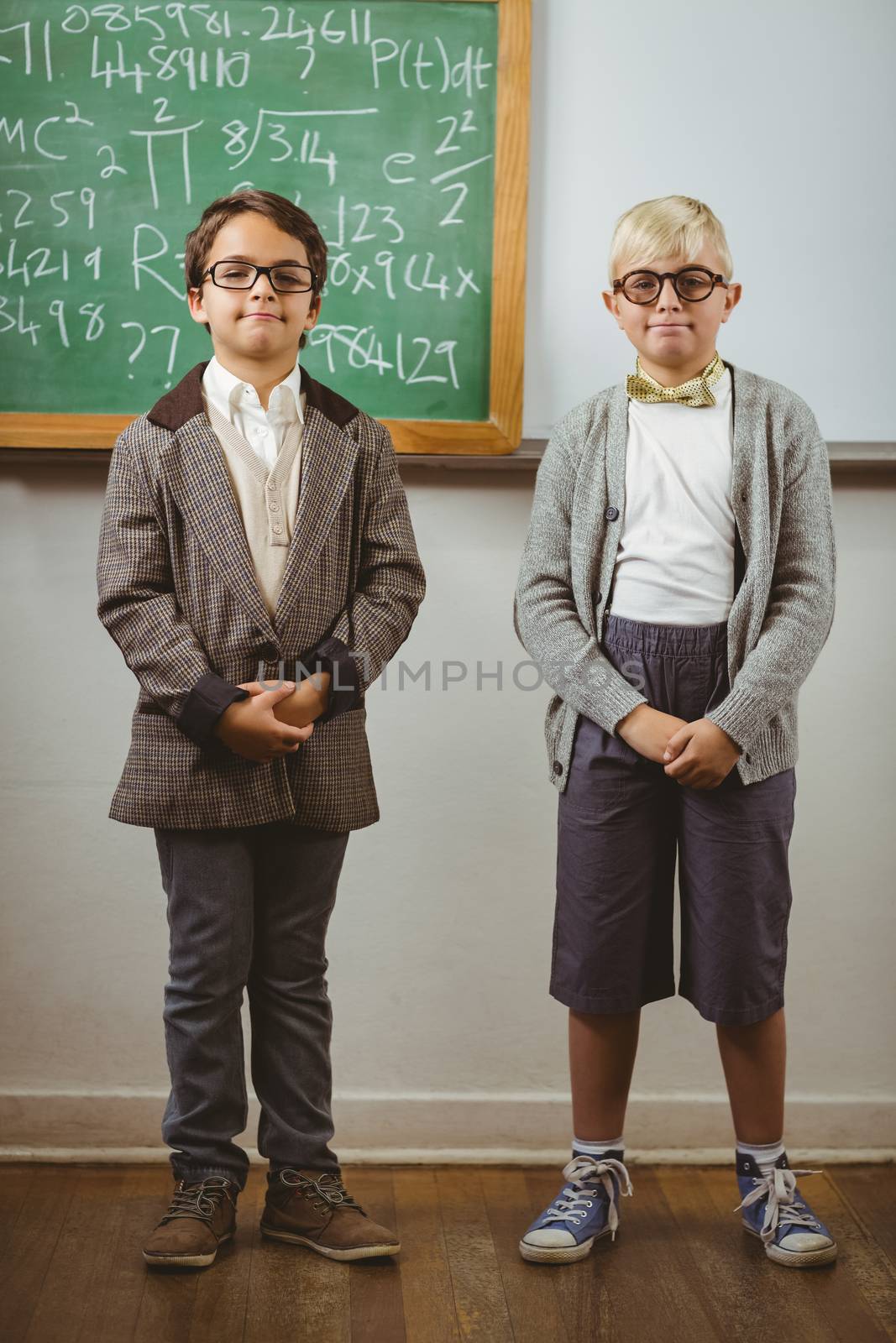 Portrait of smiling pupils dressed up as teachers in a classroom in school