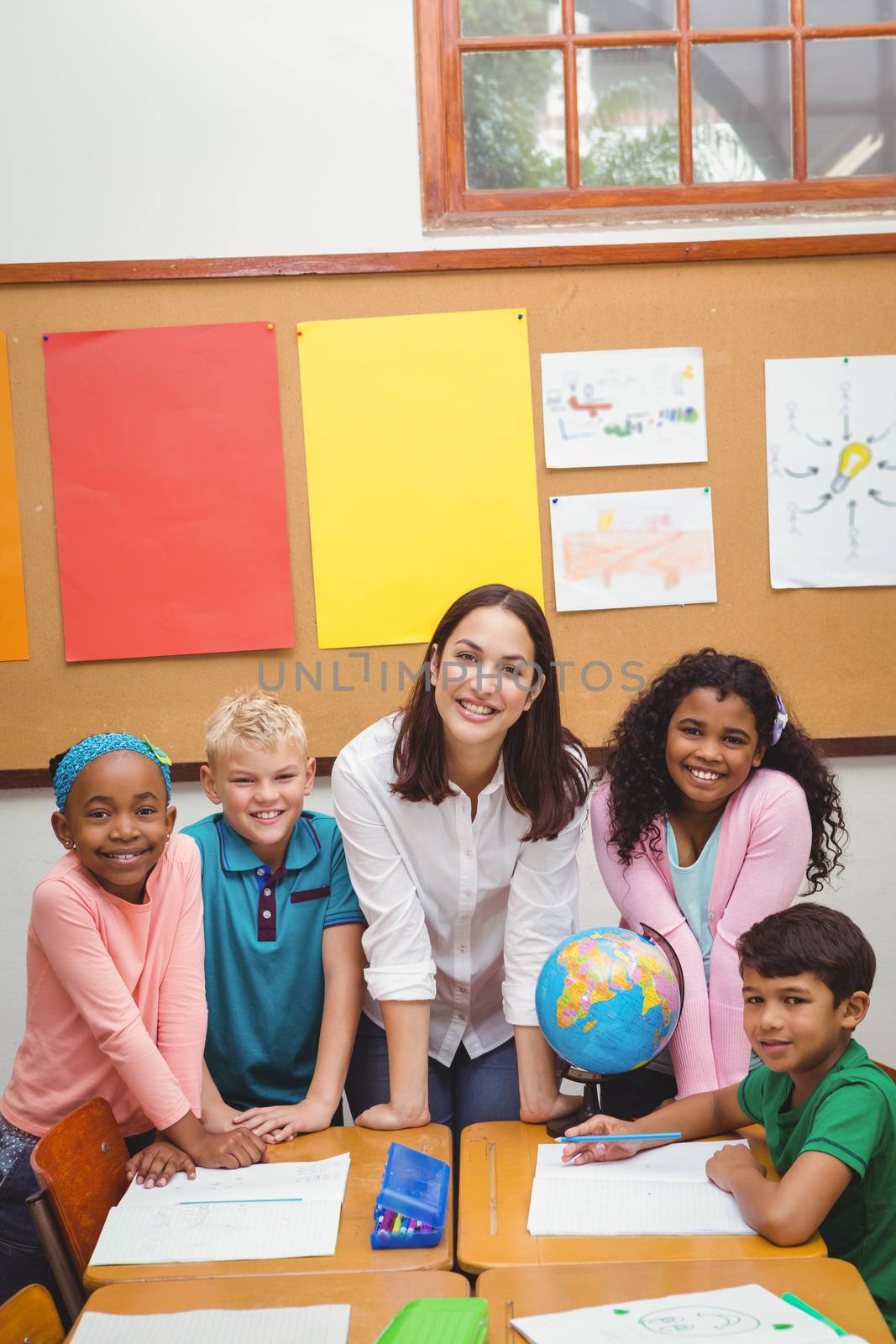 Students and teacher looking at the camera at the elementary school